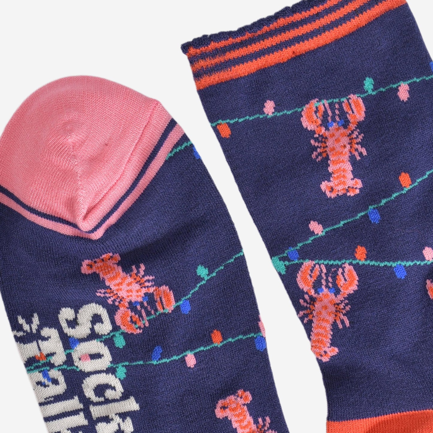 close up of the toe and cuff, the toe is pink with a navy blue border stripe, the cuff is scalloped and had coral orange stripes