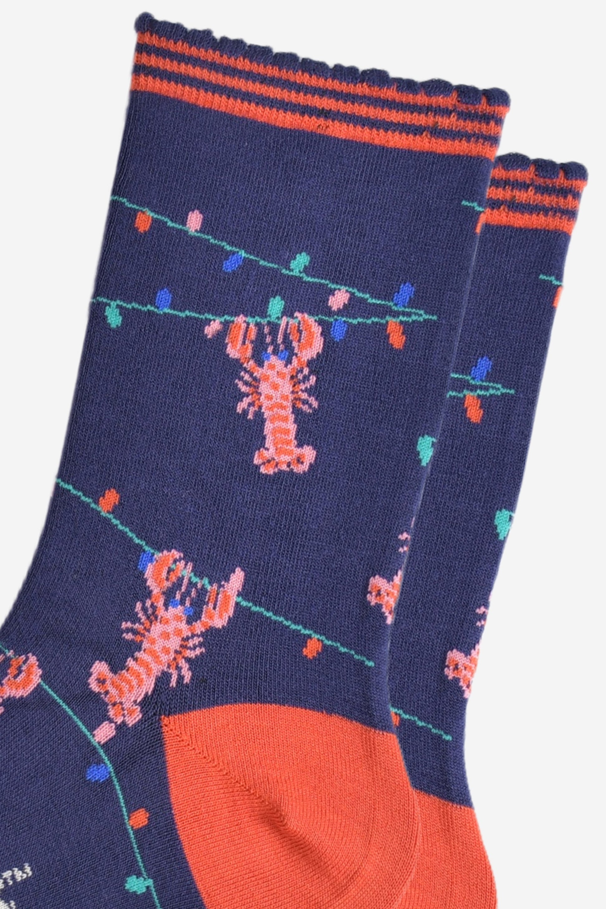 close up of the lobster and party light pattern, showing pink lobsters grabbing onto a string of colourful party lights