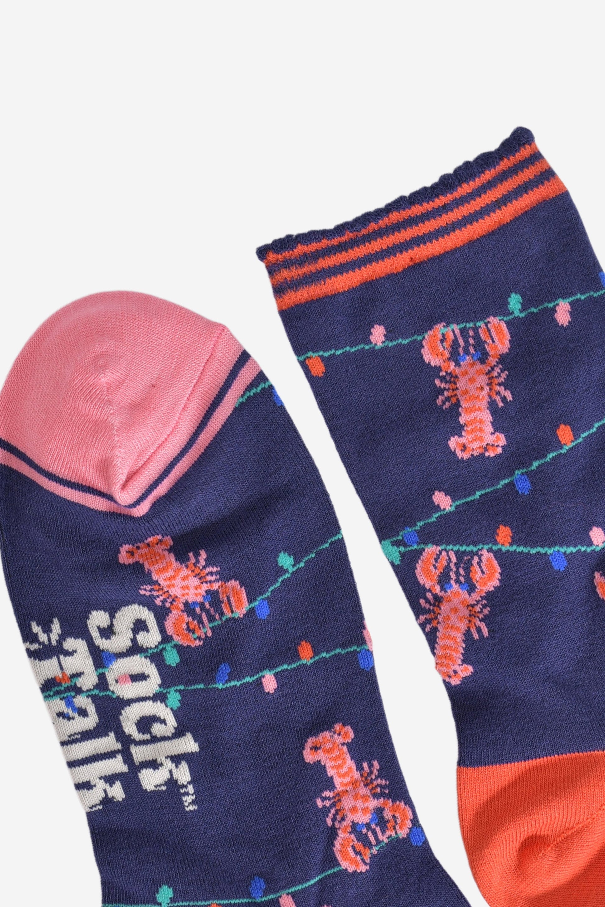 close up of the toe and cuff, the toe is pink with a navy blue border stripe, the cuff is scalloped and had coral orange stripes