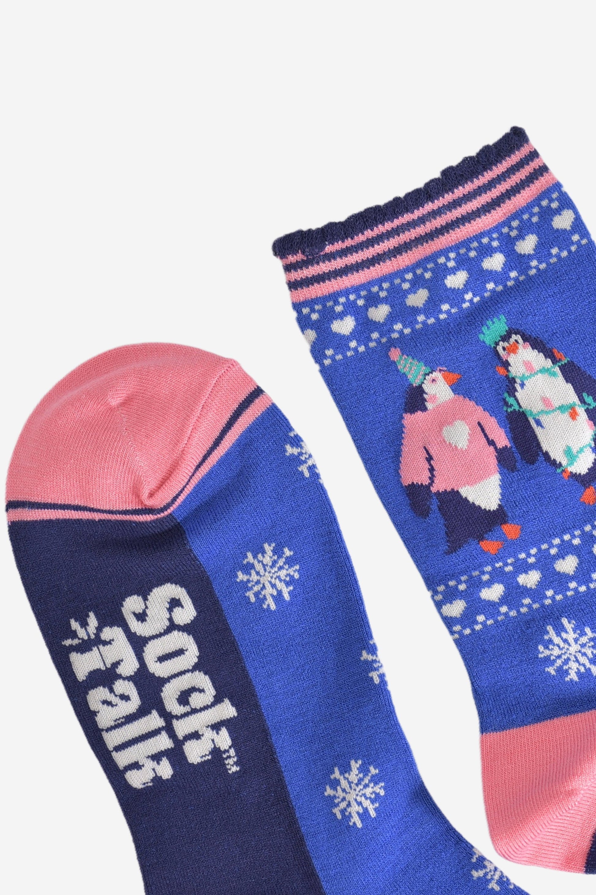 showing the toe and cuff of the socks, the toe is light pink in contrast to the blue socks, the cuff has a scalloped edge and has navy and pink stripes