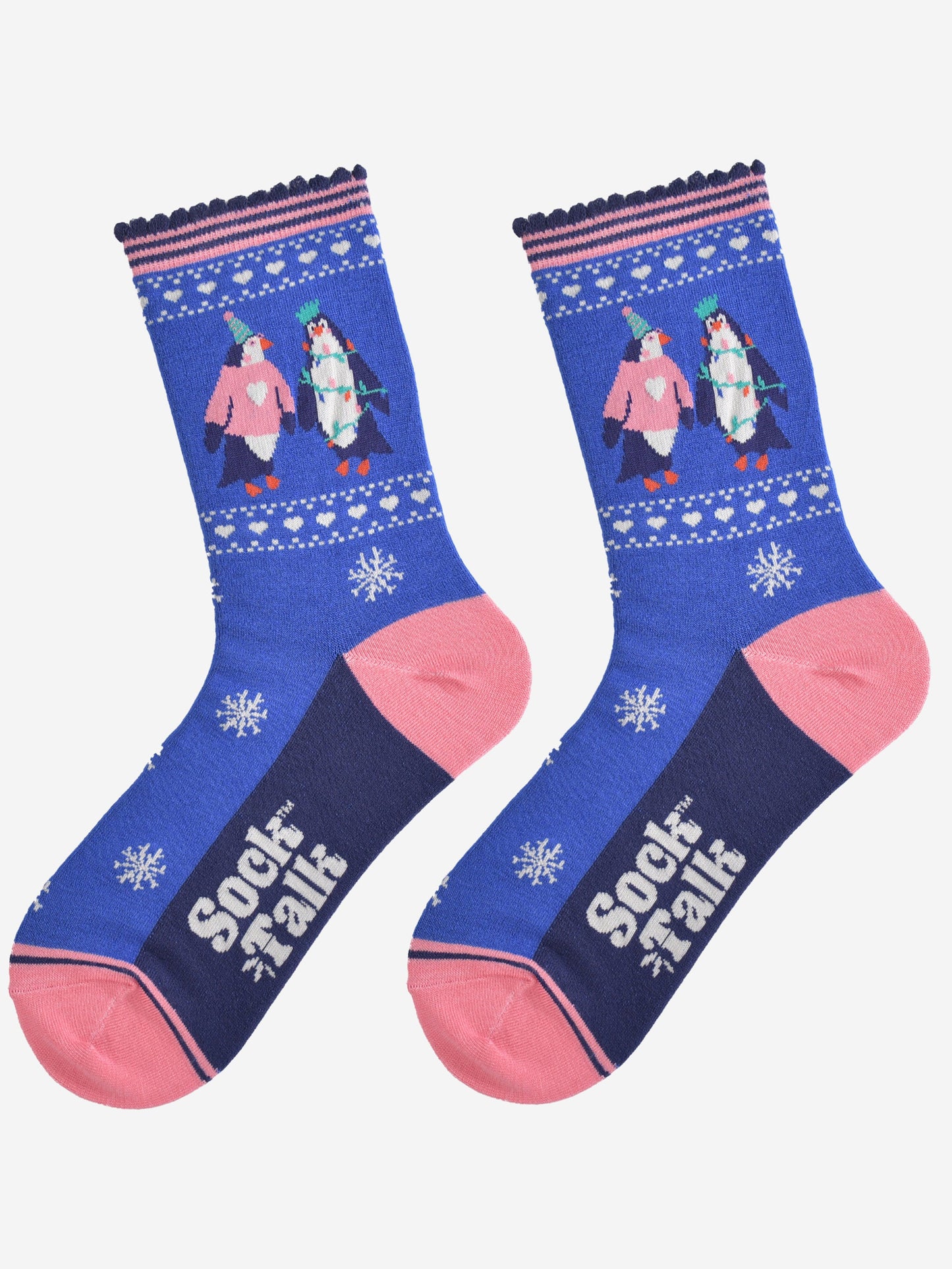 party penguin socks laying flat, showing a pattern of white snowflakes and love hearts, the socks have pink toe, heel and pink striped cuffs