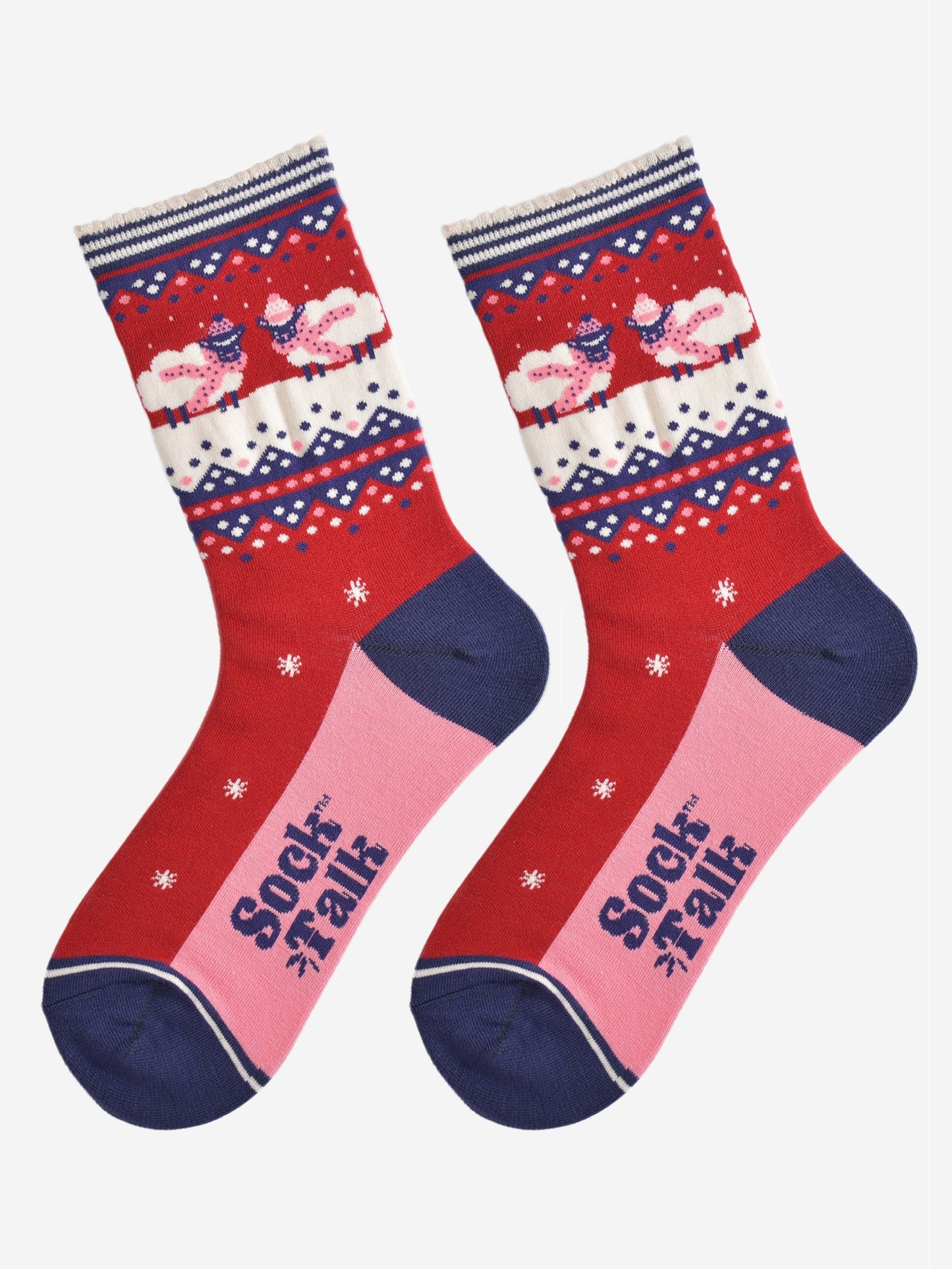 showing the socks laying flat, they have a pink sole and navy blue toe and heel in contrast to the red base of the socks. on the ankles there are sheep standing in a snowy field while wearing pink winter hats and scarves