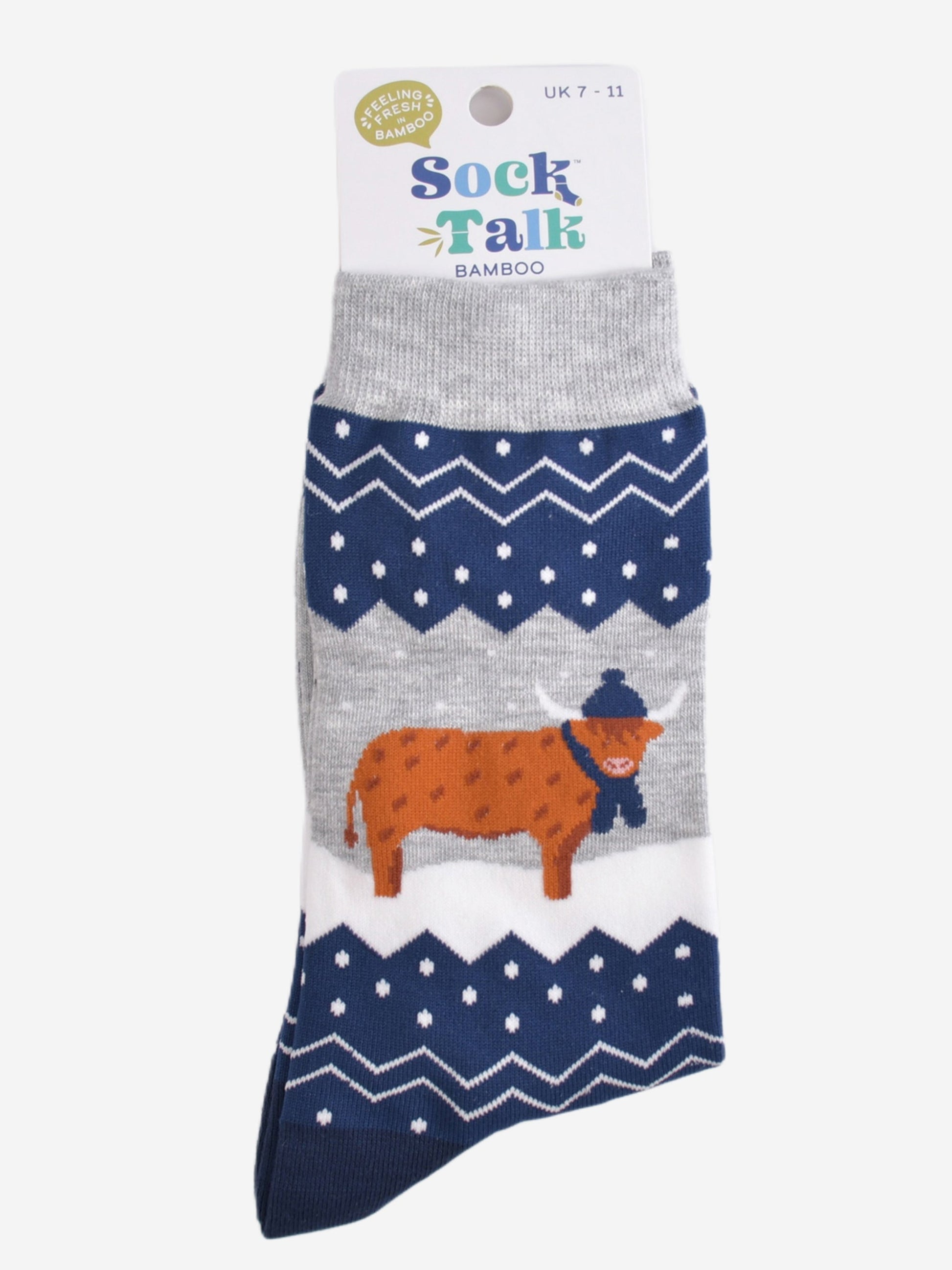 blue and grey fair isle highland cow socks in their sock talk packaging, these socks are a uk size 7-11