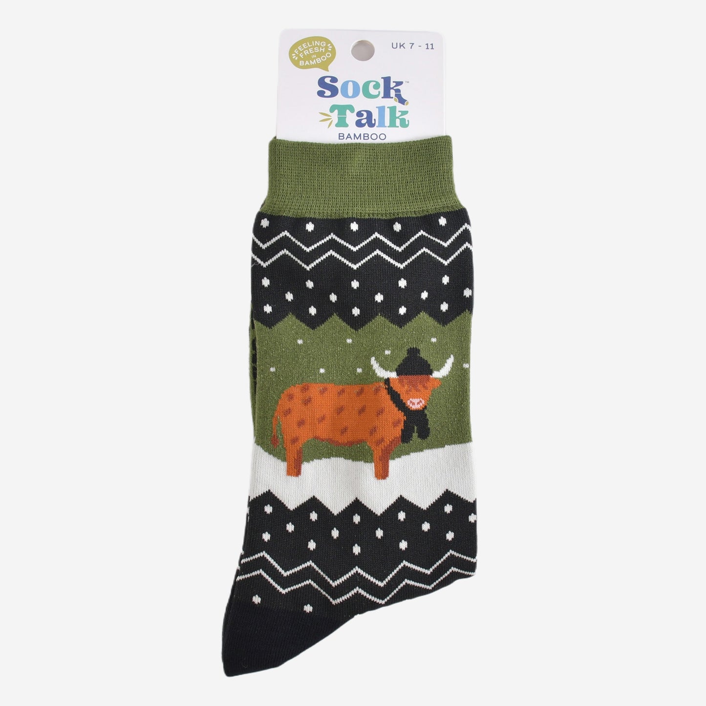 green fair isle highland cow socks in their sock talk packaging, these socks are a uk size 7-11