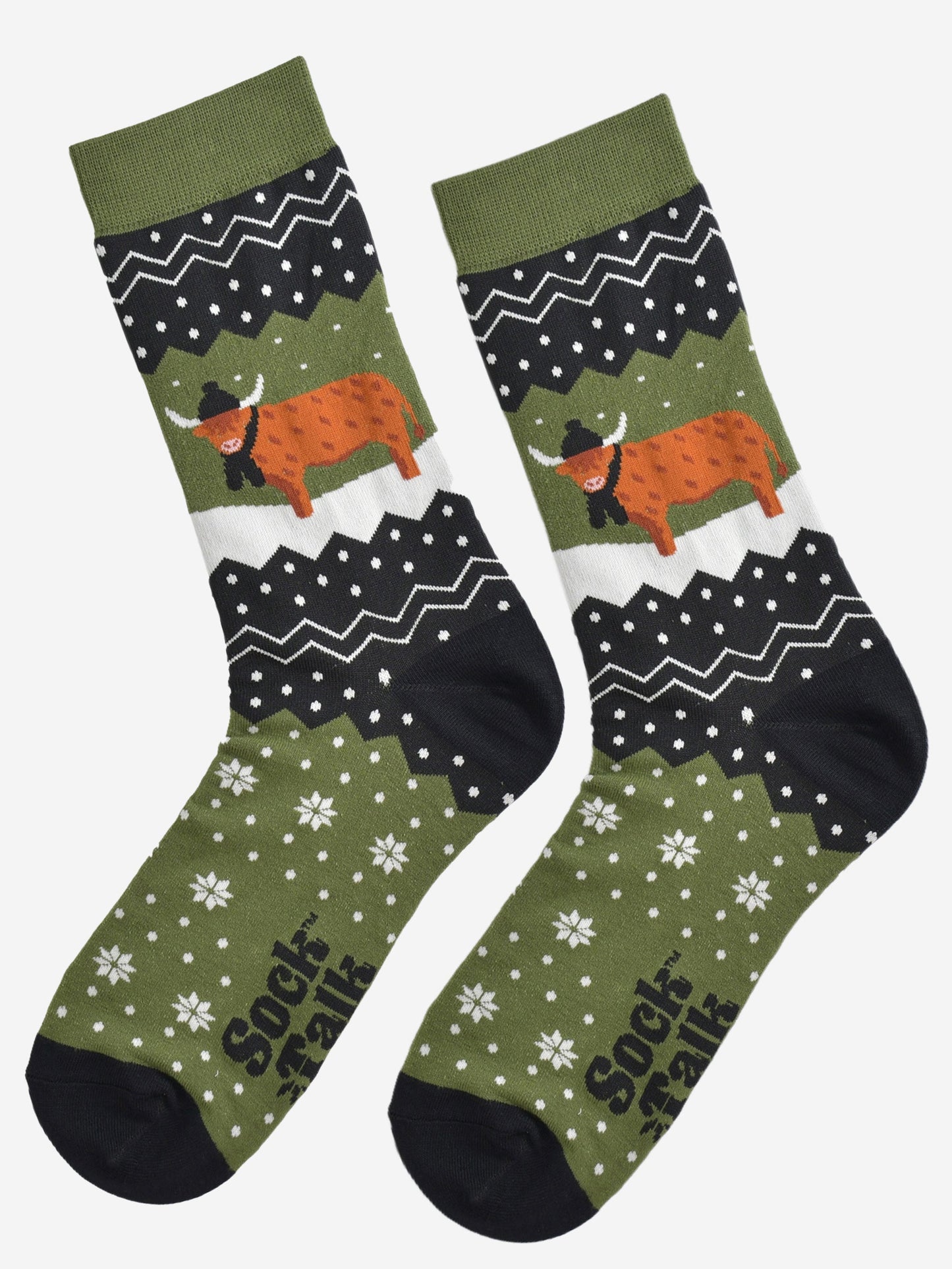 showing these green fair isle pattern highland cow socks laying flat, showing the overall festive winter pattern