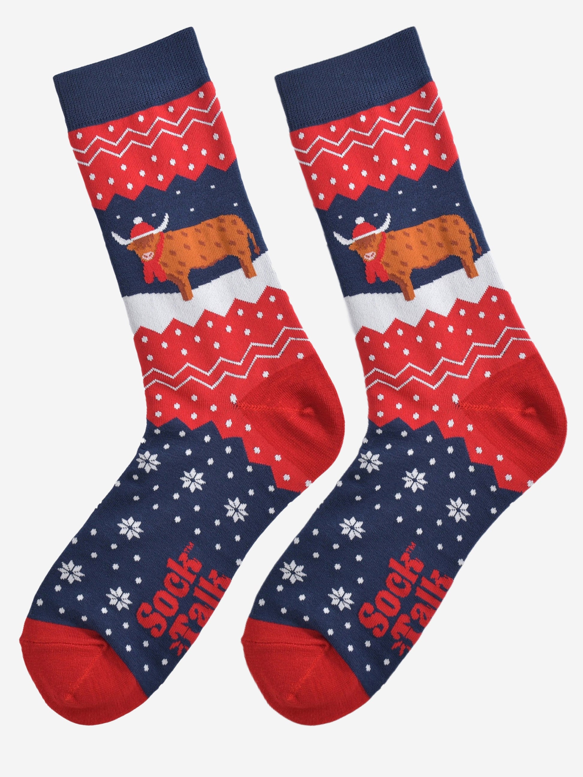showing these red and blue fair isle pattern highland cow socks laying flat, showing the overall festive winter pattern