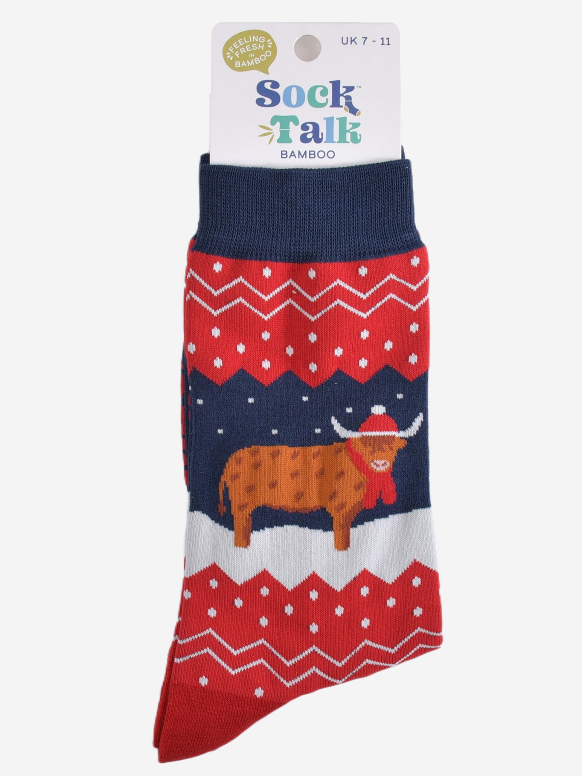 navy blue and red fair isle highland cow socks in their sock talk packaging, these socks are a uk size 7-11