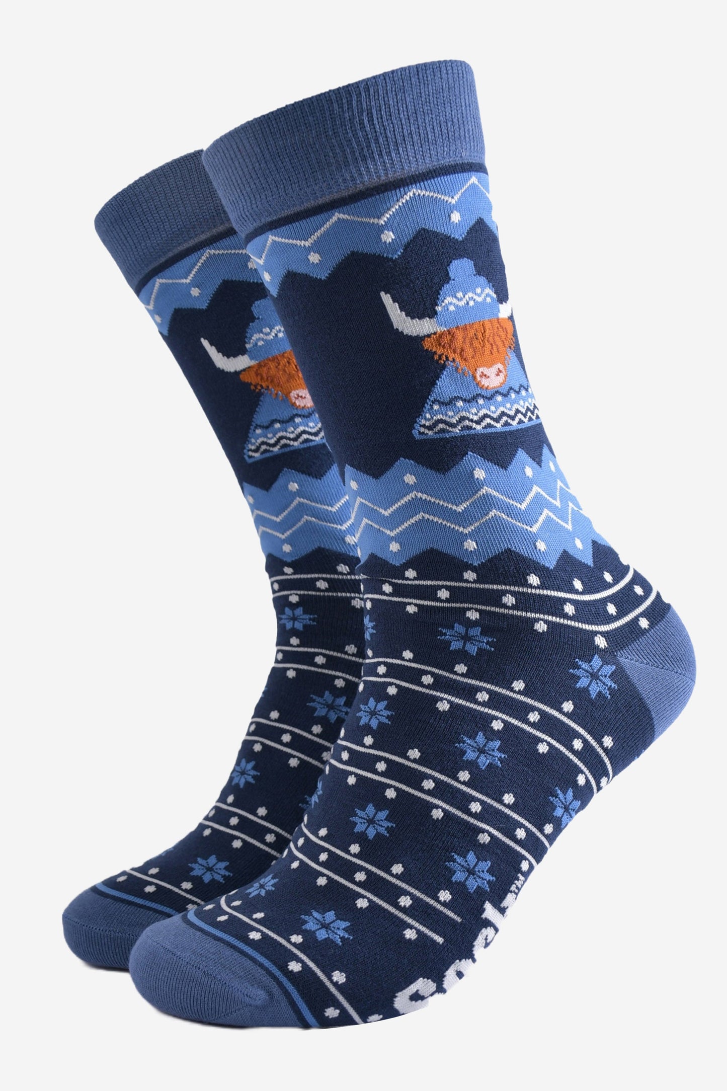 blue fair isle socks featuring a highland cow wearing a traditional knitted fair isle hat and jumper