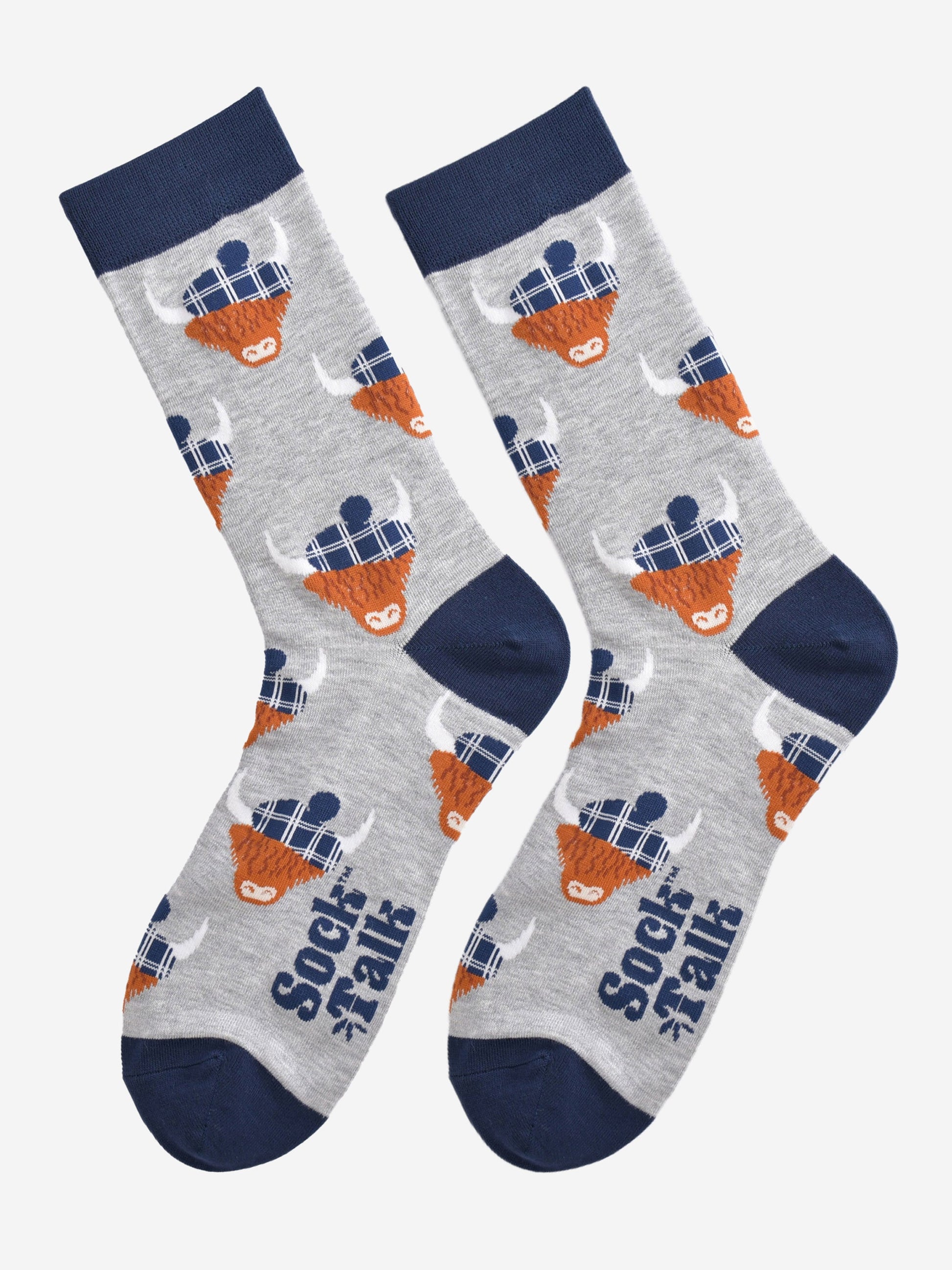 grey and navy blue highland cow bamboo socks laying flat, the highland cows are wearing blue tartan hats