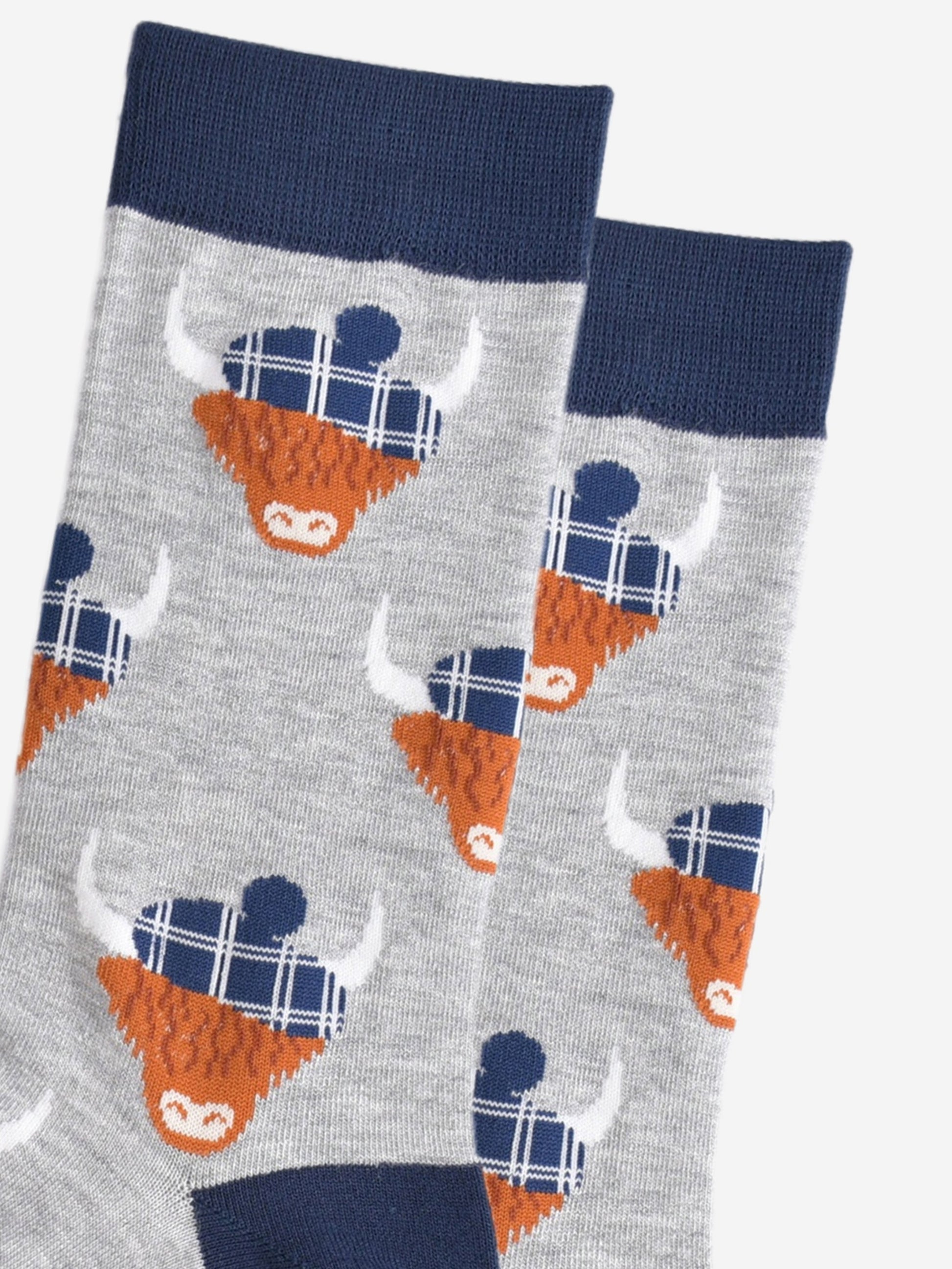close up of the highland cow pattern, showing clearly the blue tartan hats they are wearing