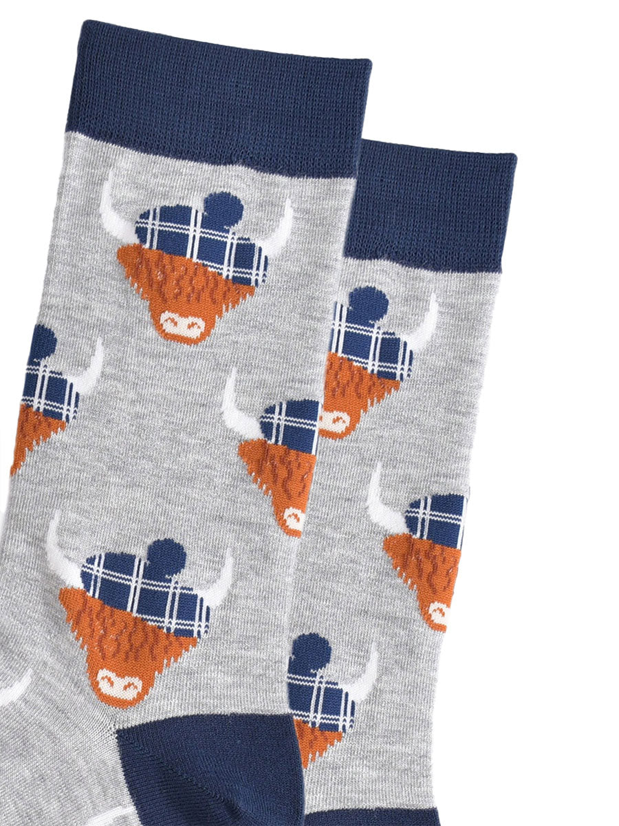 close up of the highland cow pattern, showing clearly the blue tartan hats they are wearing