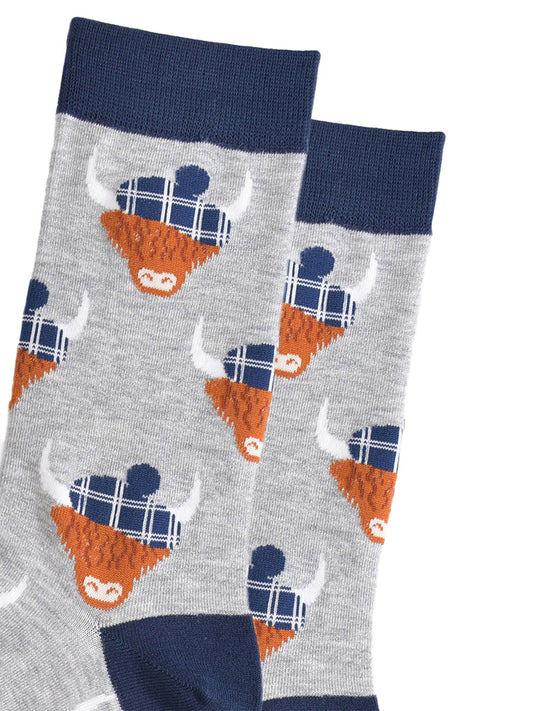 close up of the highland cow pattern, showing clearly the blue tartan hats they are wearing