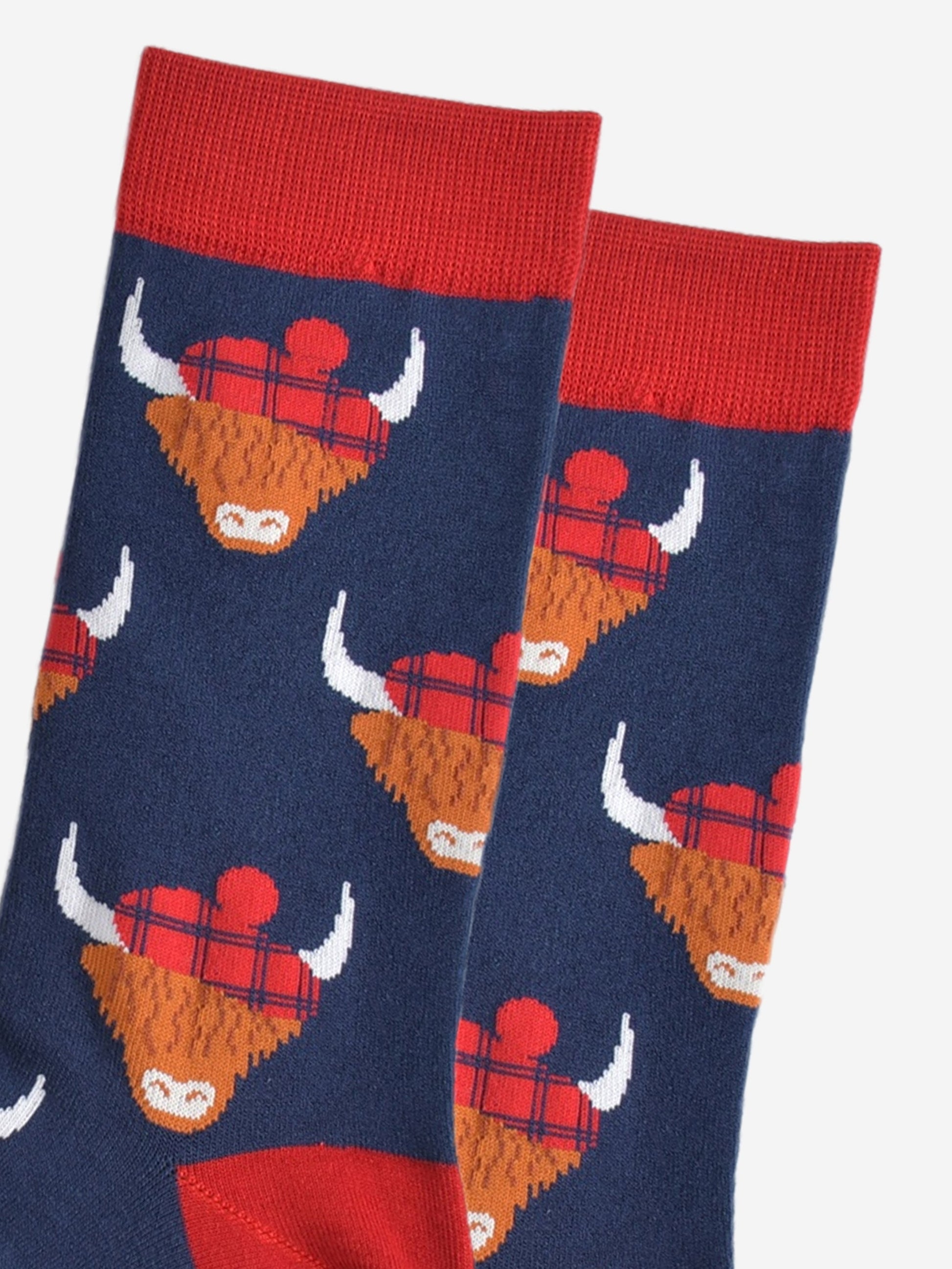 close up of the highland cow pattern, showing clearly the red tartan hats they are wearing
