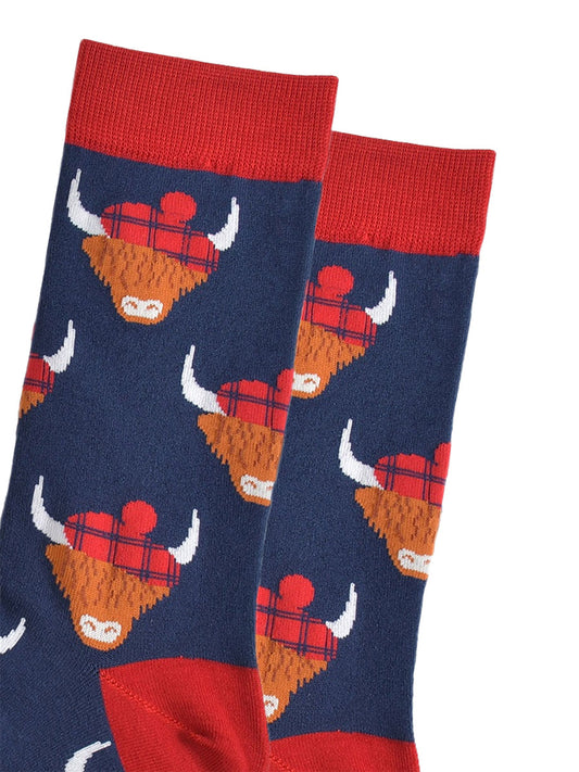 close up of the highland cow pattern, showing clearly the red tartan hats they are wearing
