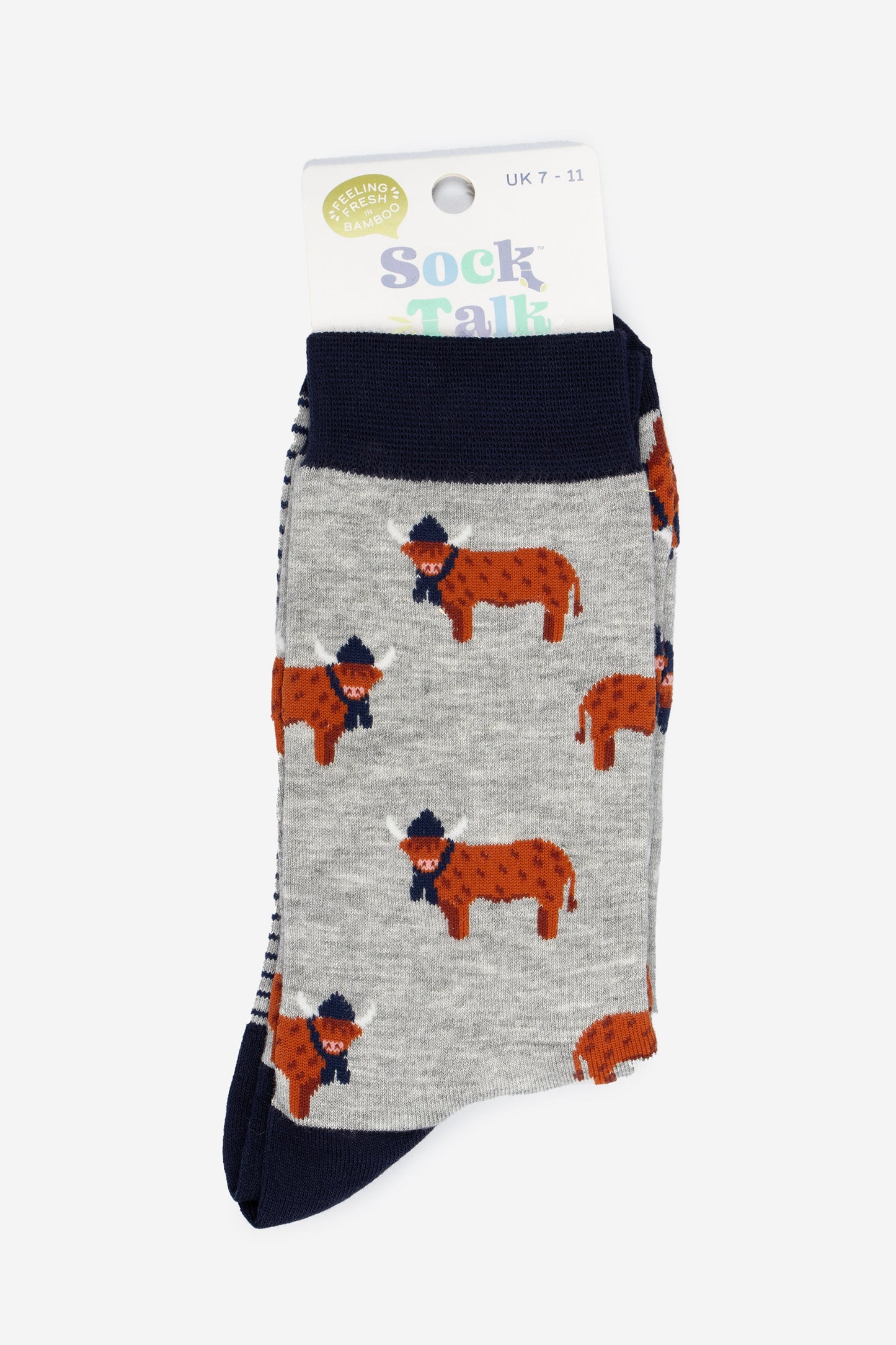 grey and navy blue highland cow bamboo socks in their sock talk packaging, these socks are uk size 7-11