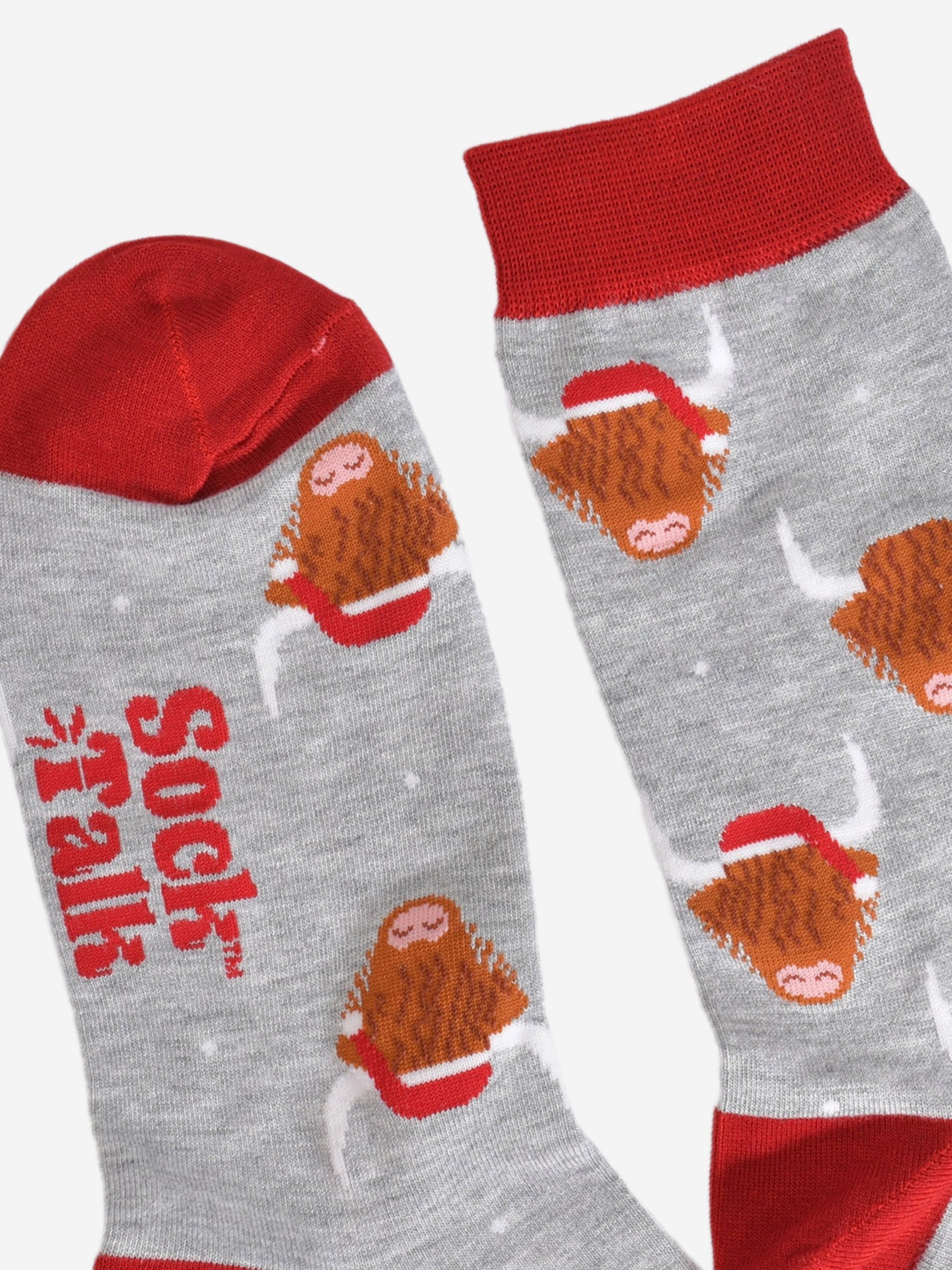 a close up of the heel and cuff of the socks, showing the all over highland cow pattern