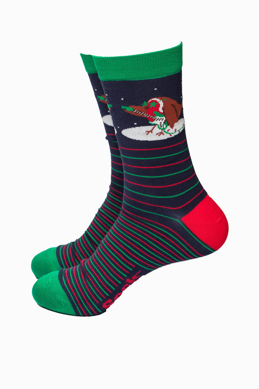 navy blue socks with green and red horizontal pin stripes, there is a red robin bird on the ankle playing an electric guitar