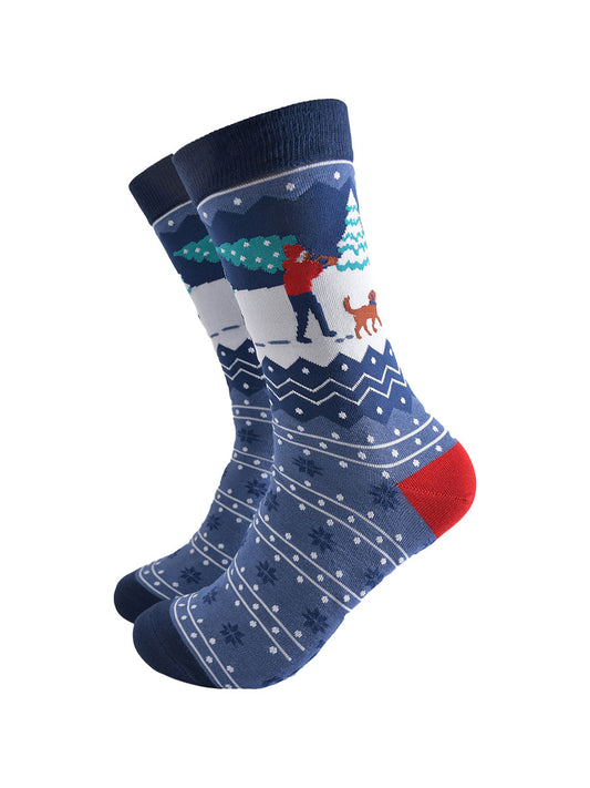 blue fair isle patterned socks featuring a dog walker carrying a xmas tree