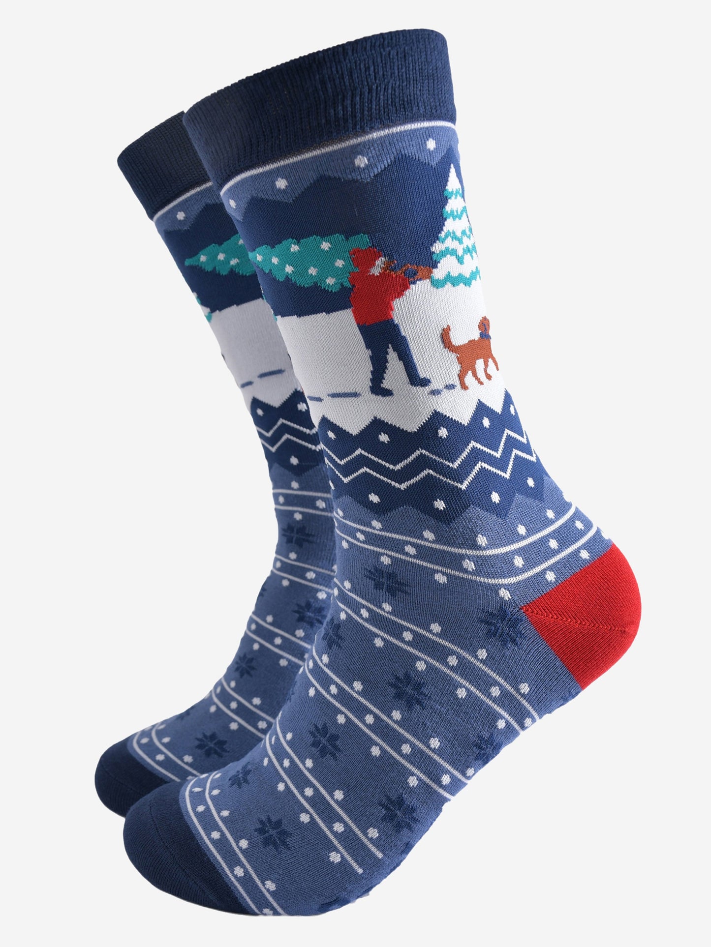 blue fair isle patterned socks featuring a dog walker carrying a xmas tree