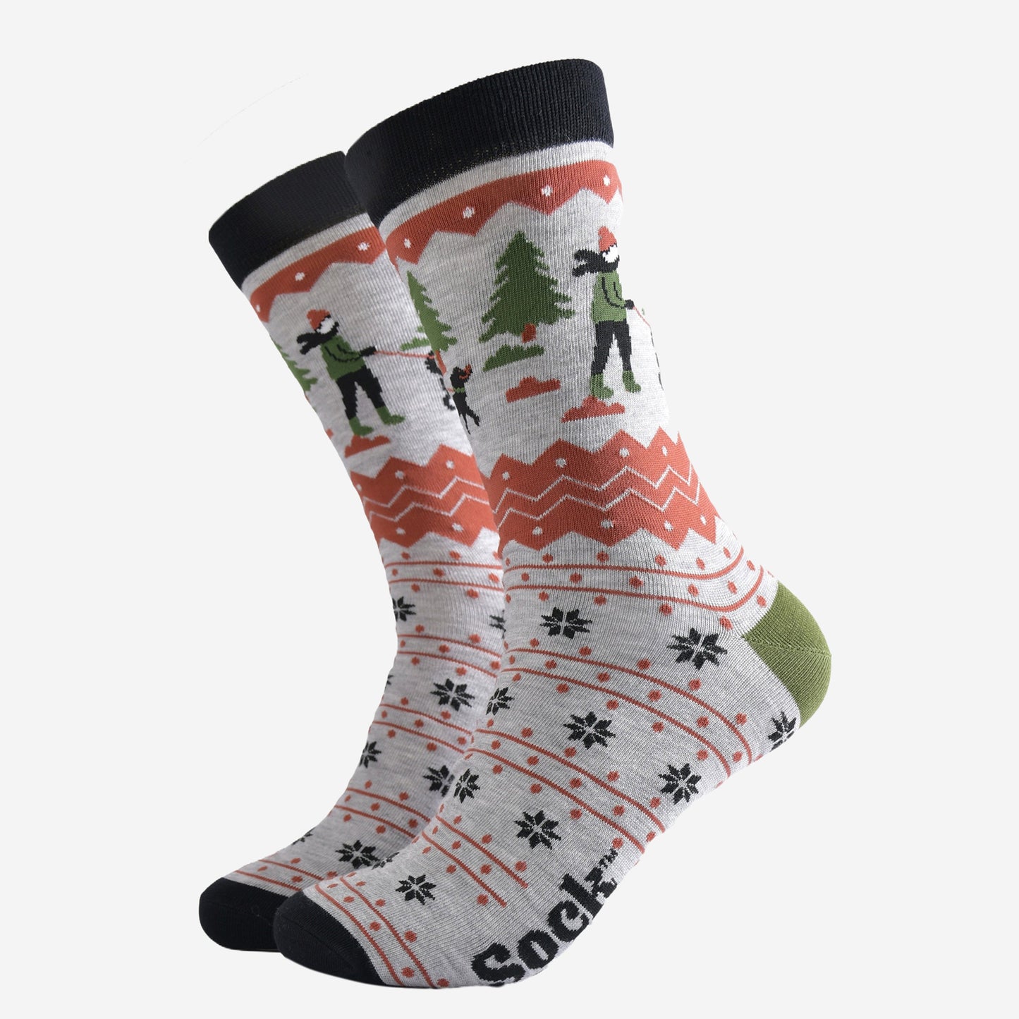 grey bamboo socks with a fair isle pattern in orange and black featuring a dog walker and a winter scene