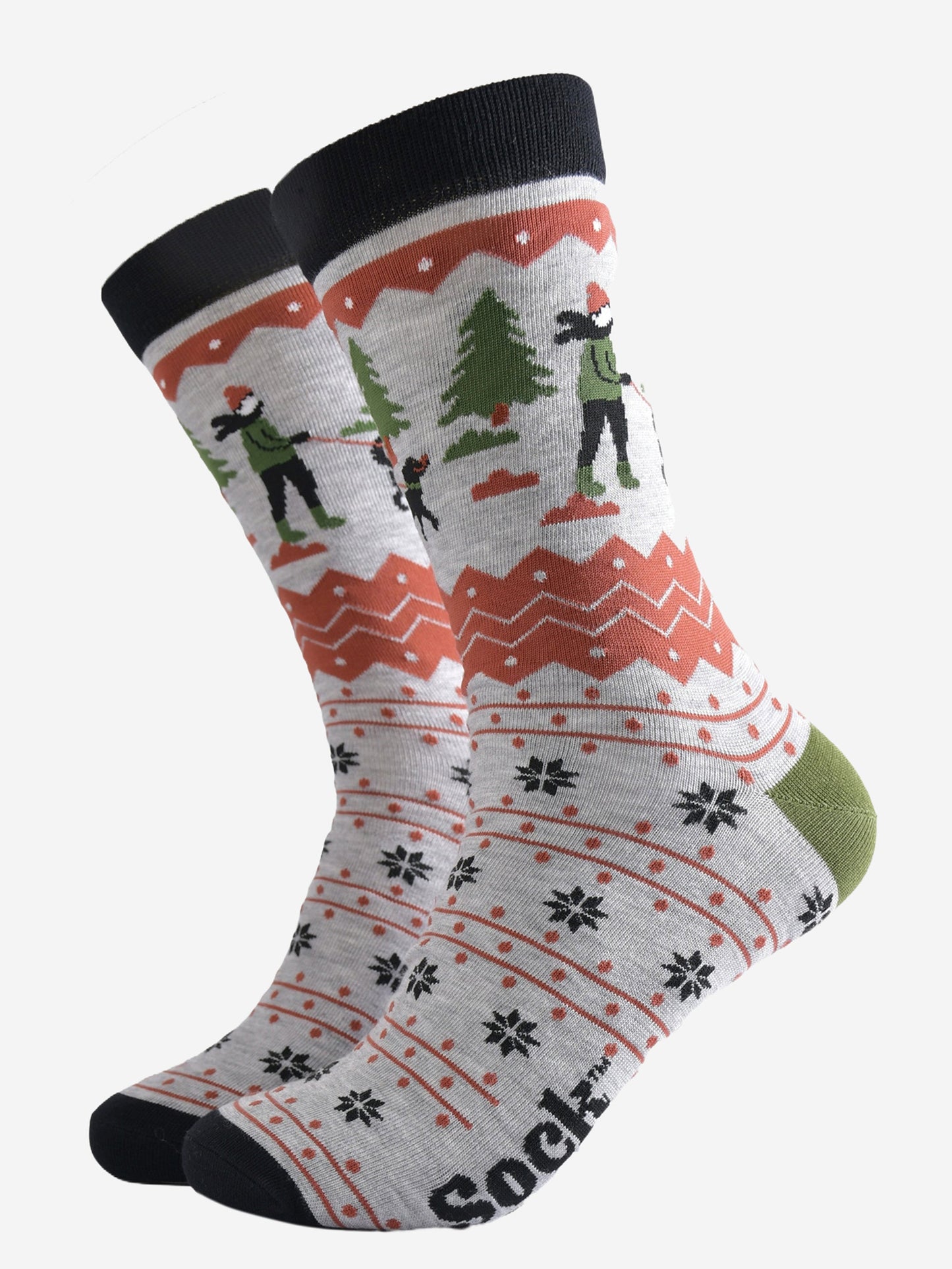 grey bamboo socks with a fair isle pattern in orange and black featuring a dog walker and a winter scene