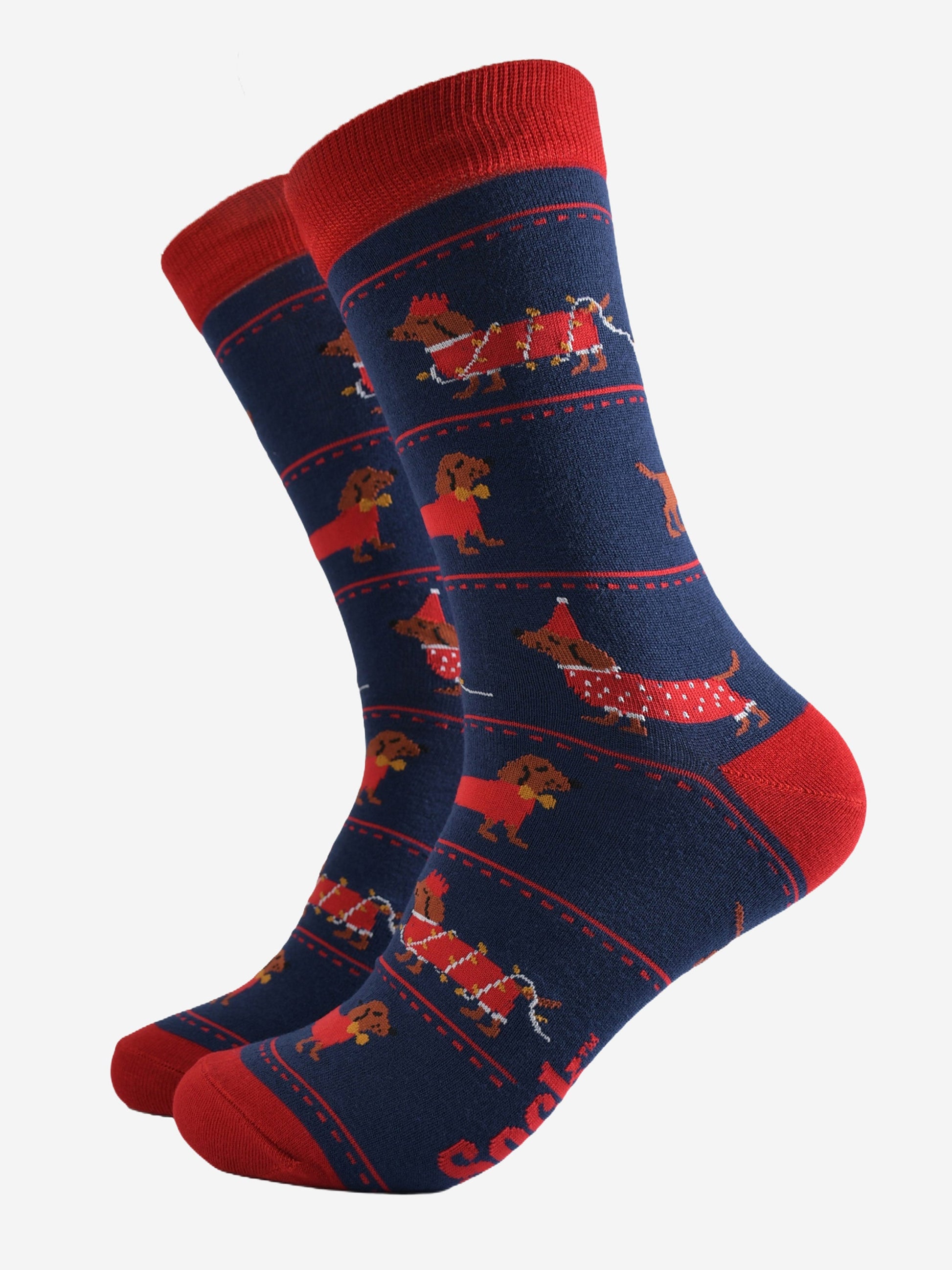 navy blue socks with a pattern on sausage dogs playing with party lights and wearing party hats