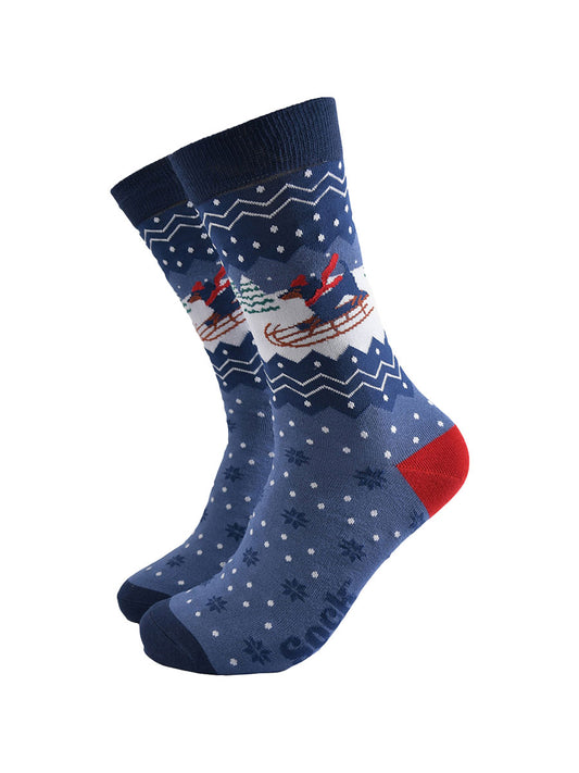 blue socks with a sledging sausage dog and fair isle inspired pattern
