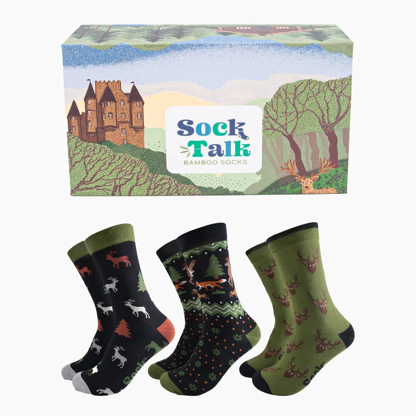 three pairs of woodland animal bamboo dress socks in a gift box designed to look like the scottish highlands. the box has a castle, stag and forest