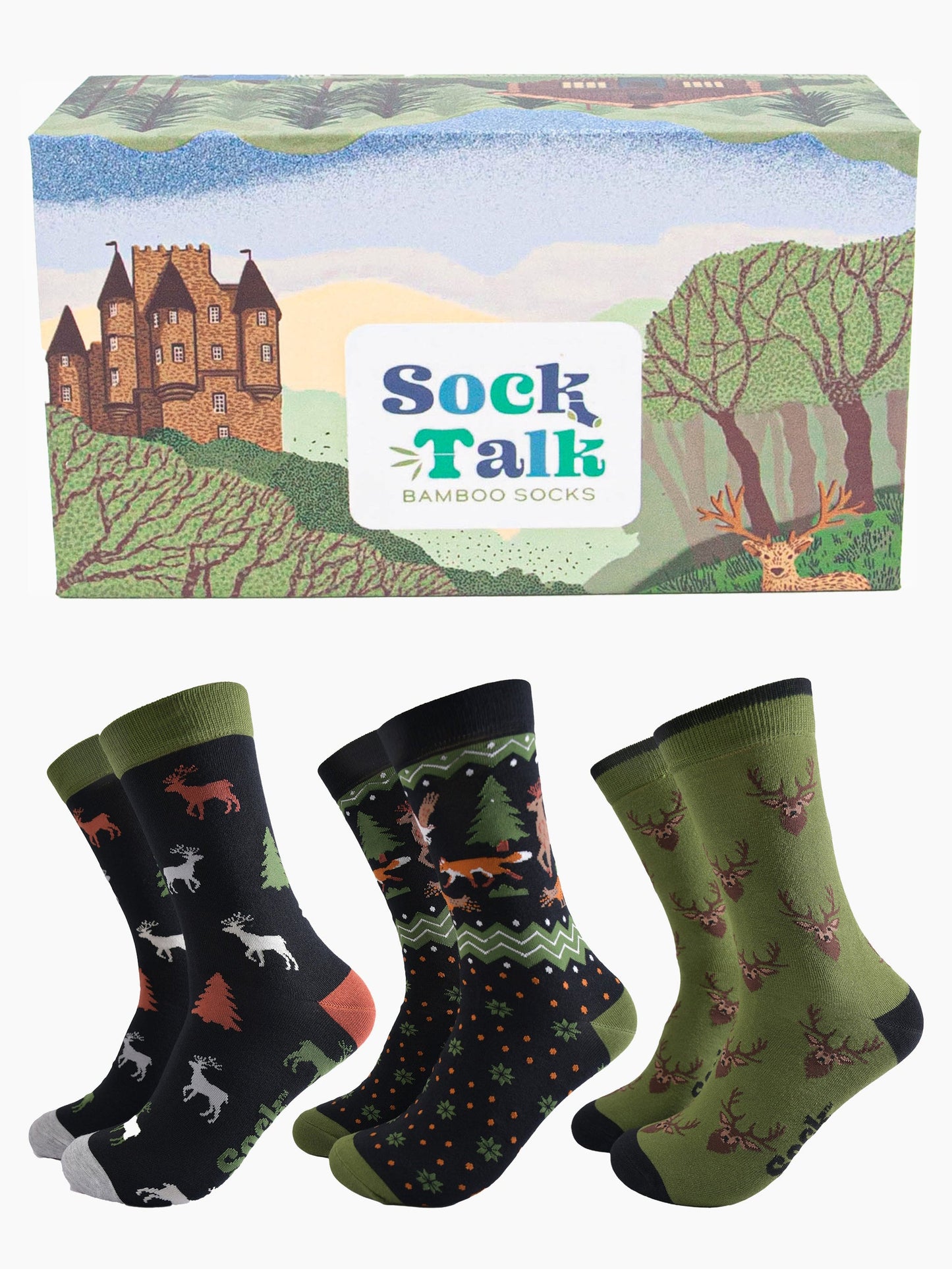 three pairs of woodland animal bamboo dress socks in a gift box designed to look like the scottish highlands. the box has a castle, stag and forest