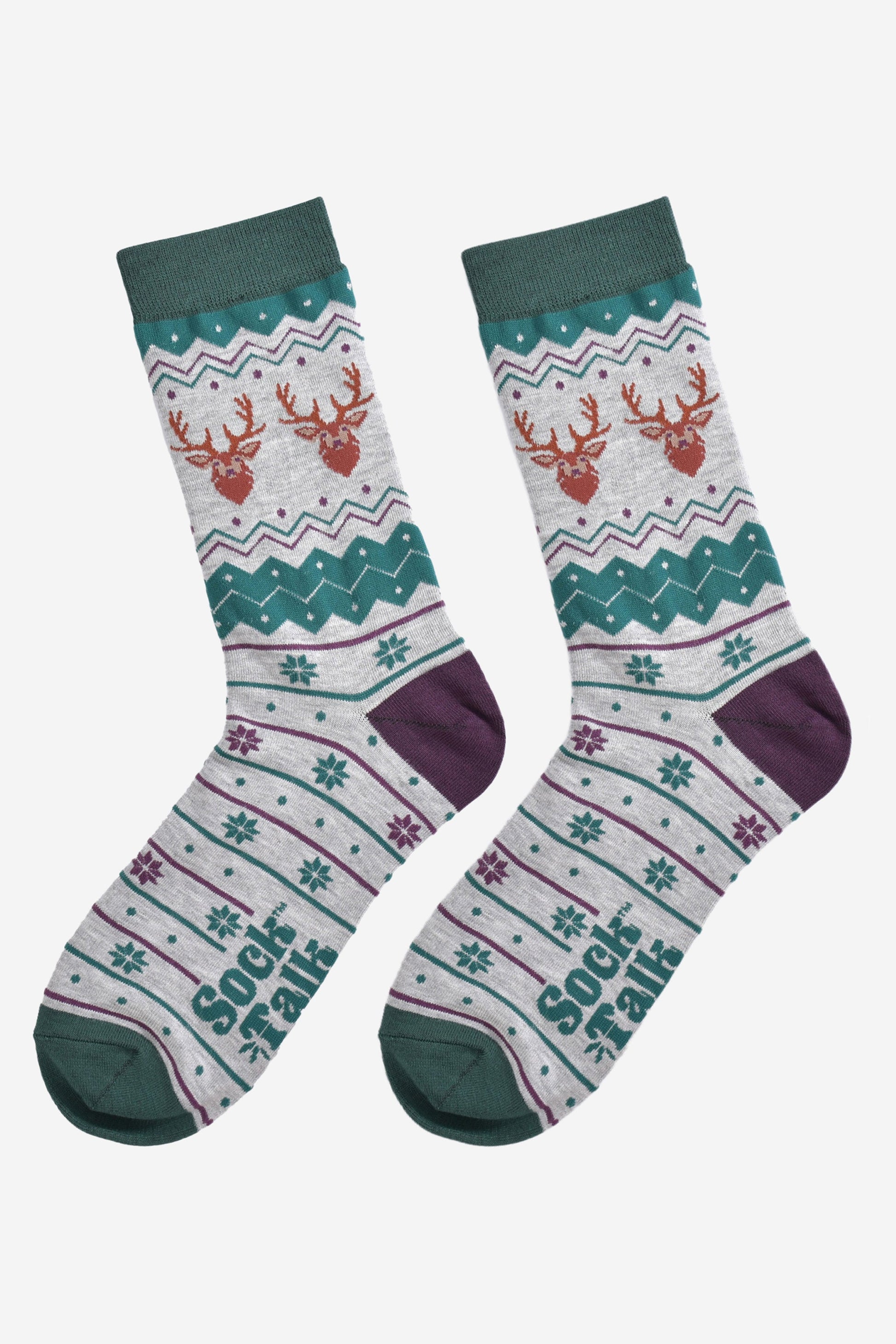 fair isle stag socks laying flat, showing the grey and green fair isle pattern and the two stags heads on each side of the ankles