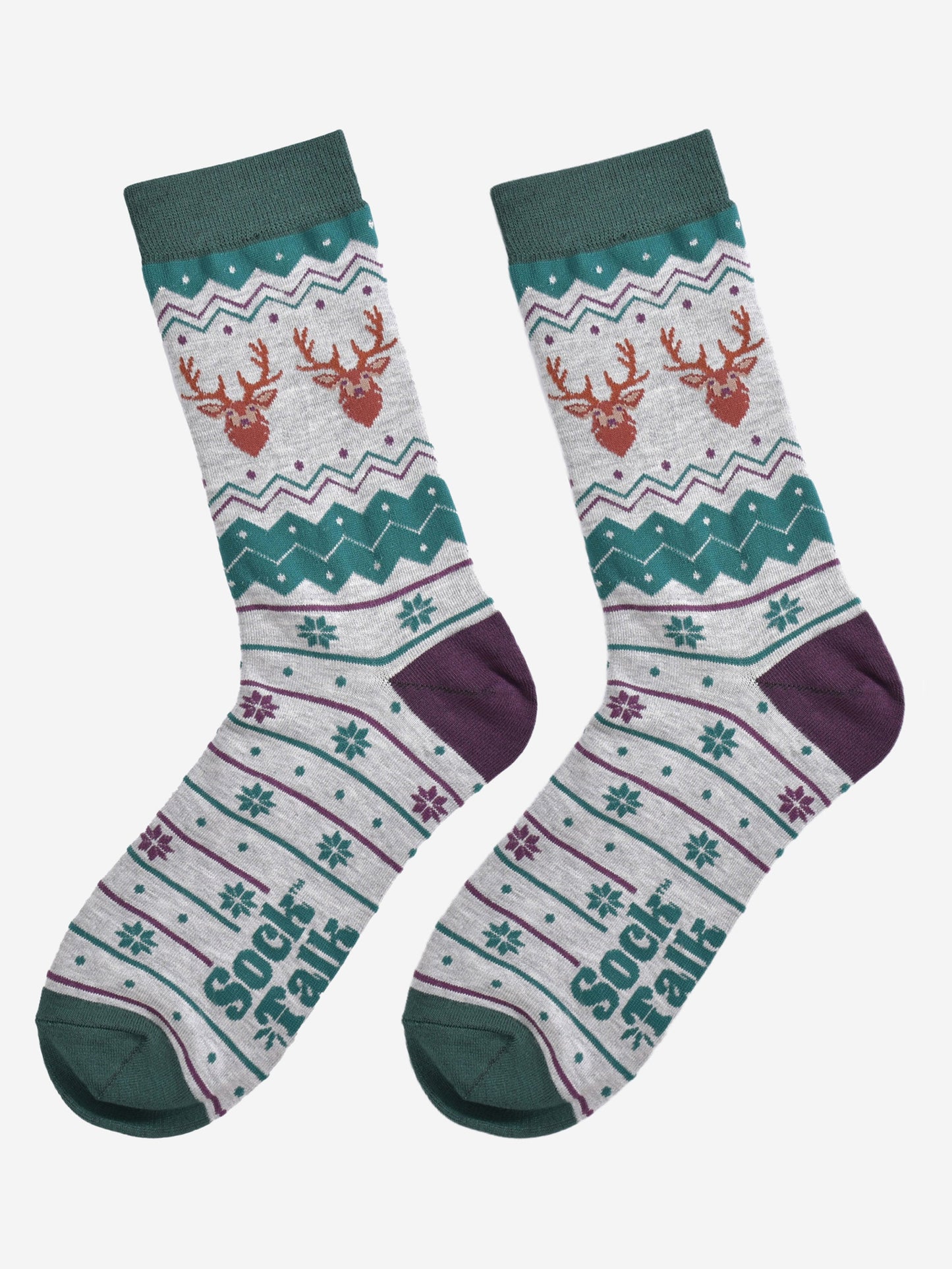 fair isle stag socks laying flat, showing the grey and green fair isle pattern and the two stags heads on each side of the ankles