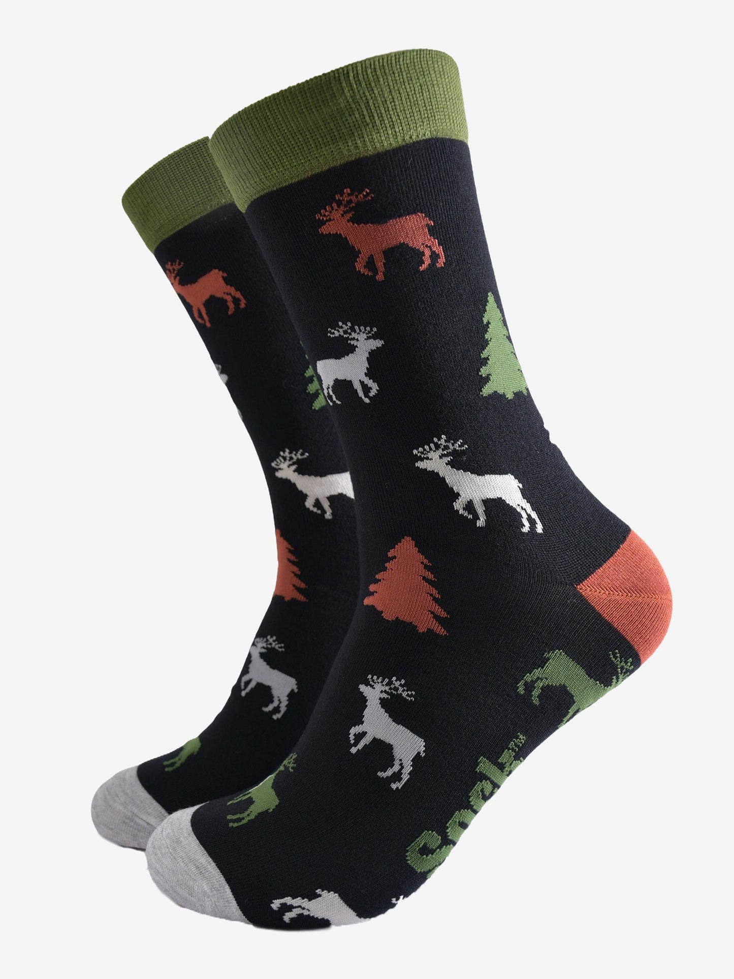 black crew socks with green cuff, grey toe and orange heel with a pattern of stags and christmas trees all over