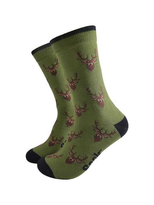 green socks with black heel, toe and cuff with an all over pattern of brown stags heads.