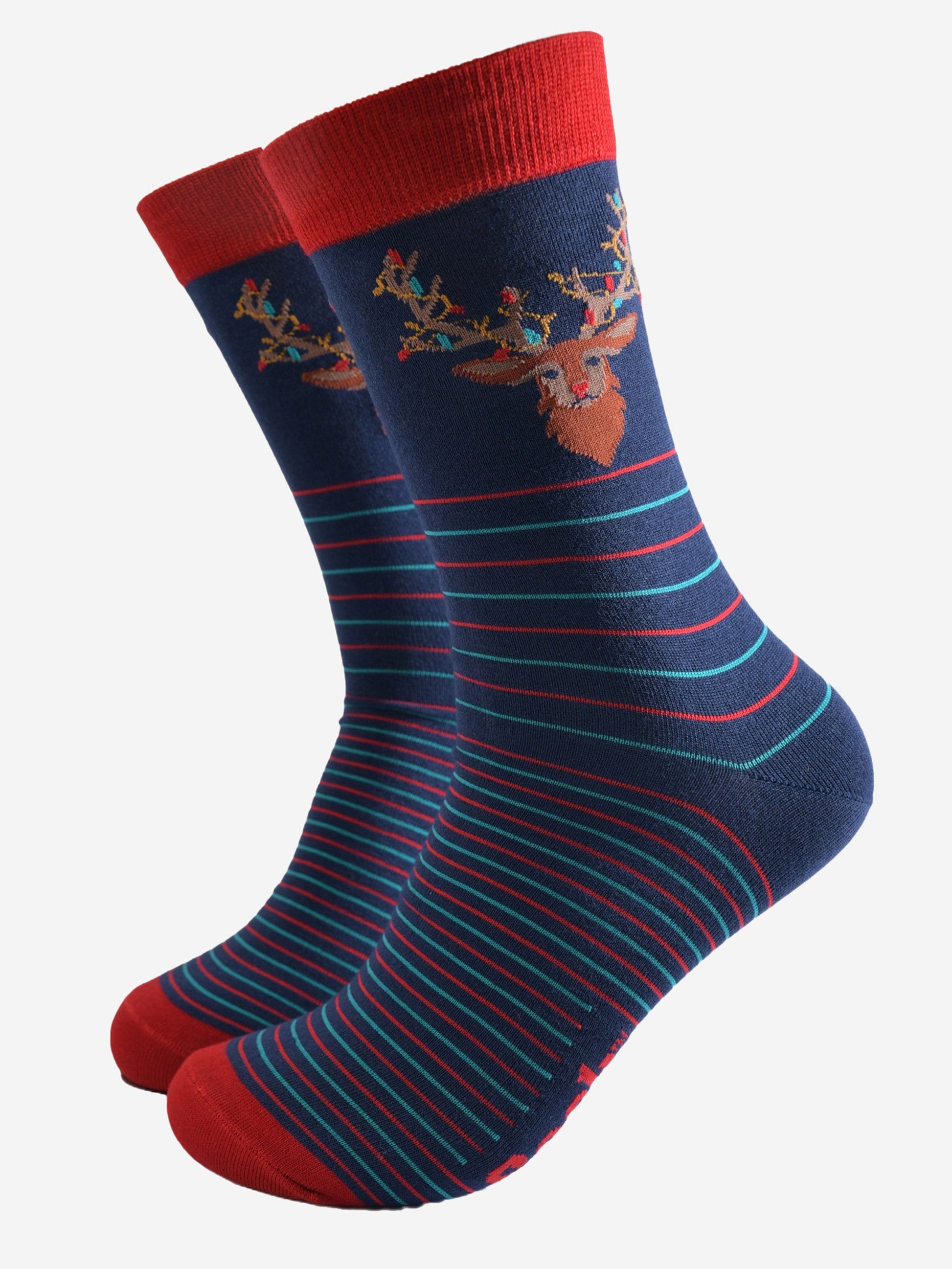 navy blue socks with a red cuff and toe with a red and green horizontal striped pattern with a stags head on the ankle, the stag is draped with colourful party lights