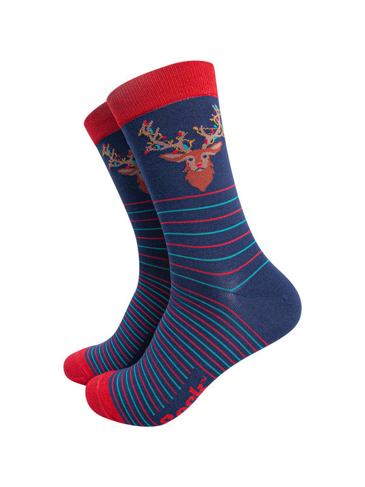 navy blue socks with a red cuff and toe with a red and green horizontal striped pattern with a stags head on the ankle, the stag is draped with colourful party lights