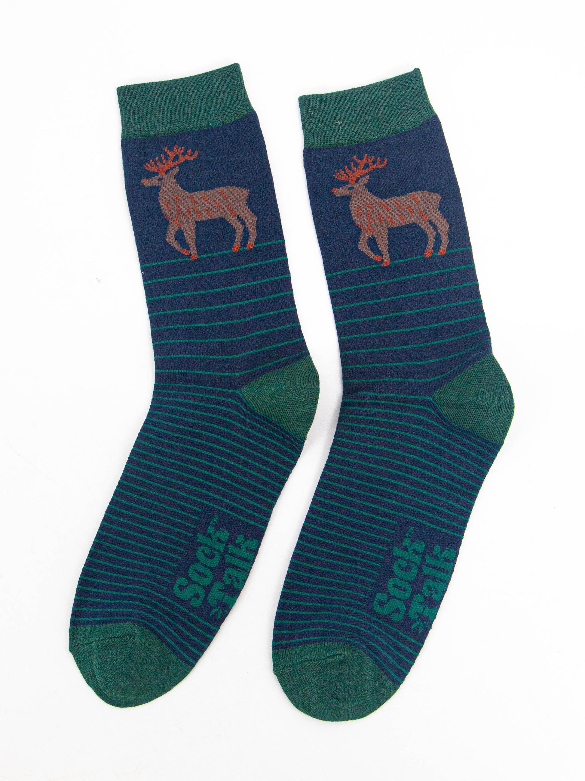 showing the navy and green striped stag socks laying flat, showing the stripe pattern and large stag standing in profile on the ankle of the socks