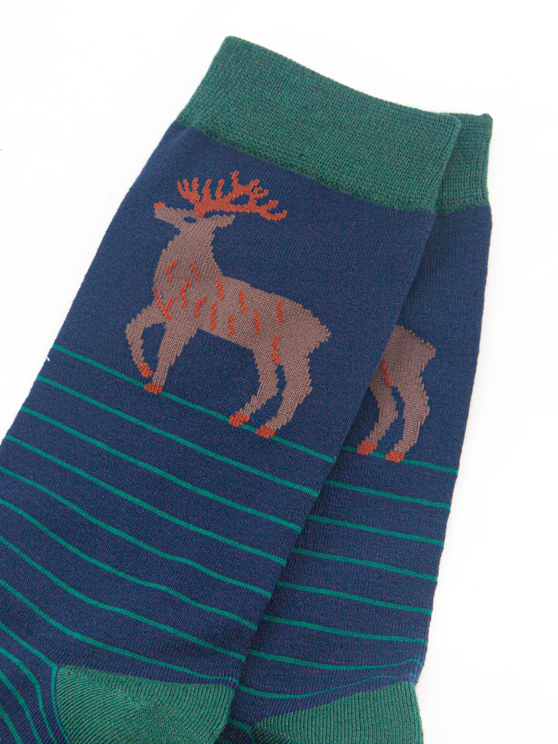 close up of the stag design on the ankle of the socks, the stag is brown with orange antlers