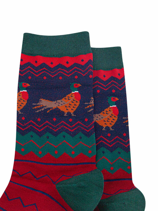 close up of the pheasant pattern on the ankle of the socks, the birds are brown and orange with red bellies and a green and red head. 