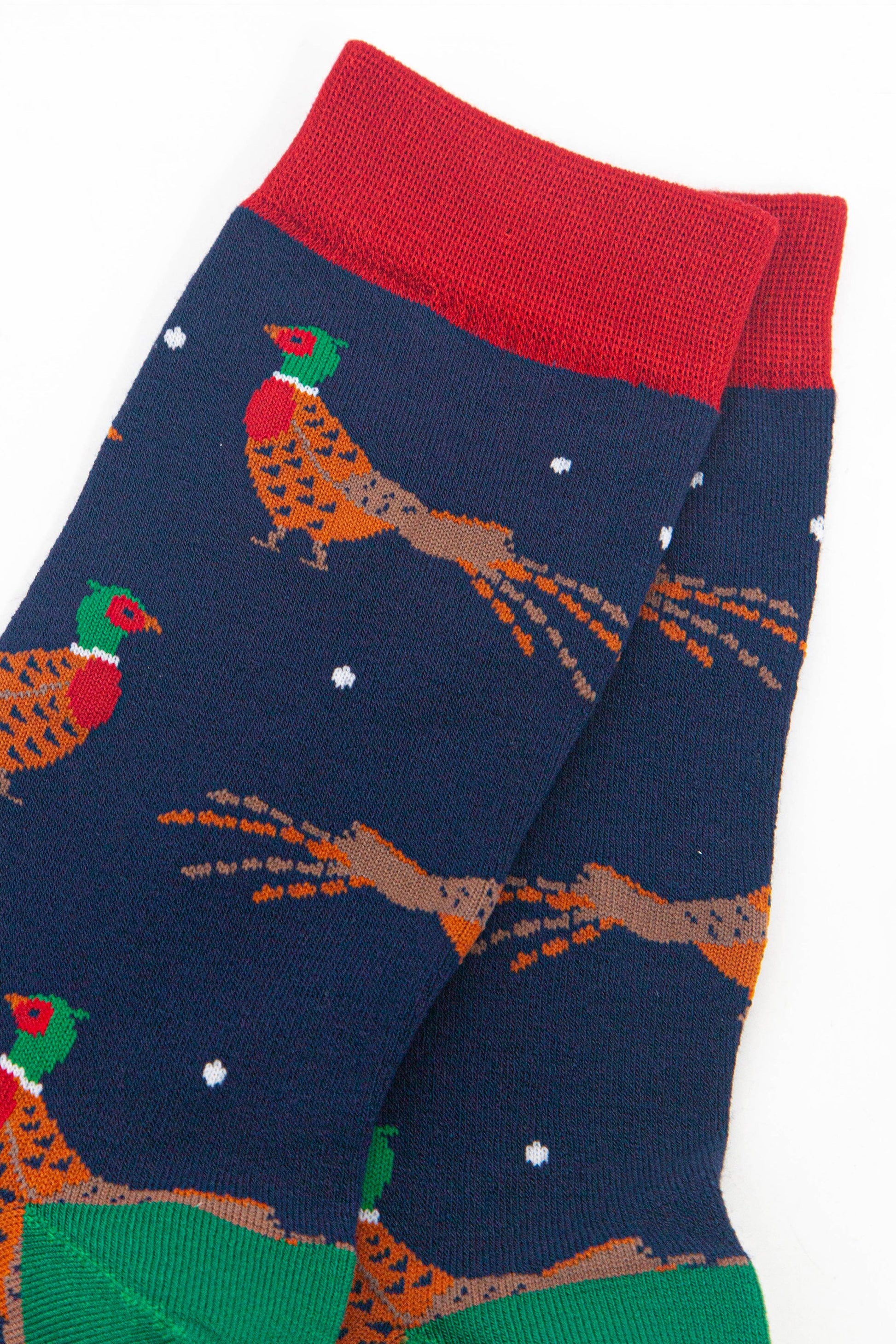 close up of the woodland pheasant design, the pheasants are orange and brown with red bellies and green and red heads. 
