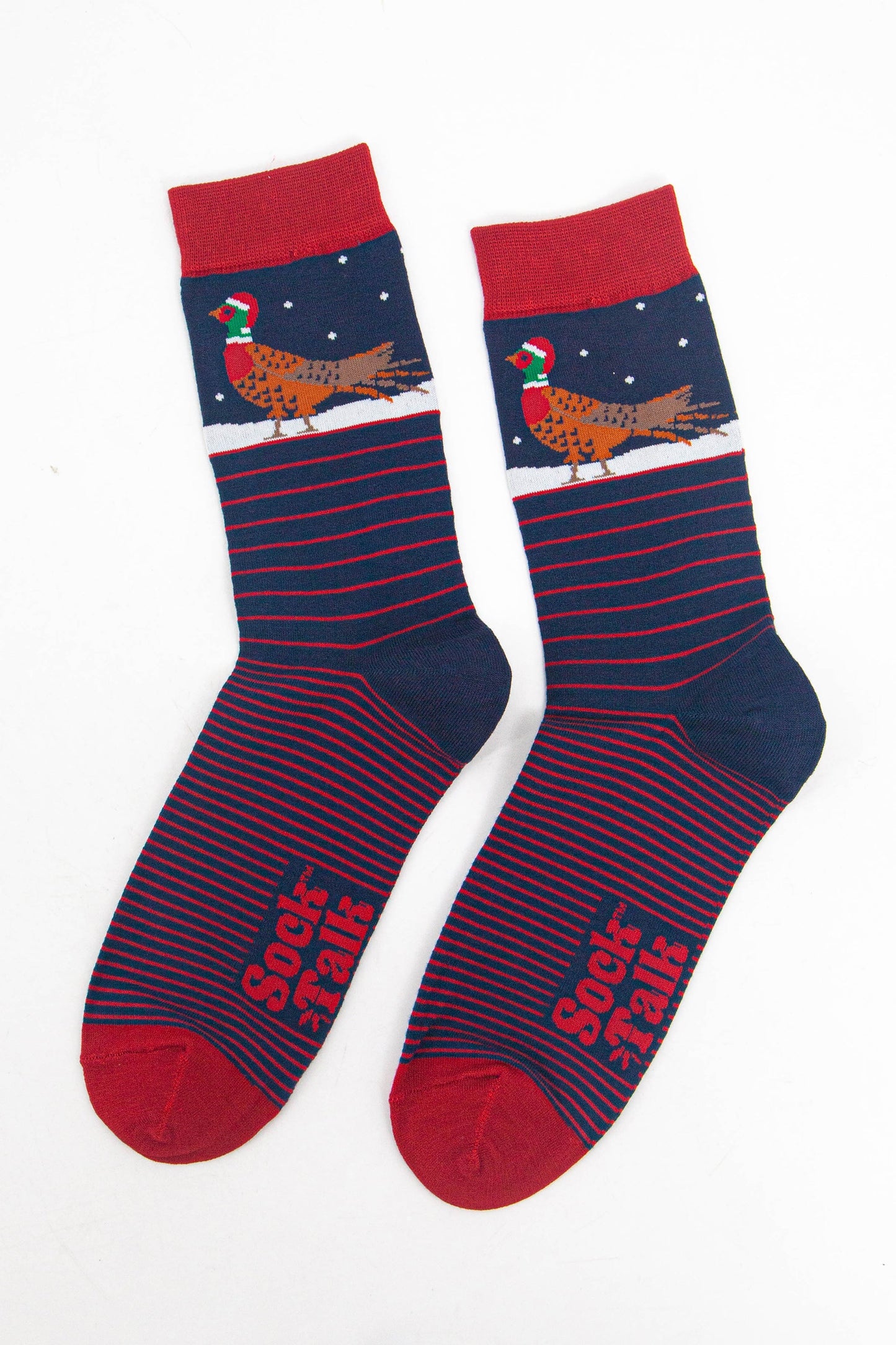 showing the socks laying flat, displaying the red stripe pattern and contrasting christmas pheasant pattern on the ankles