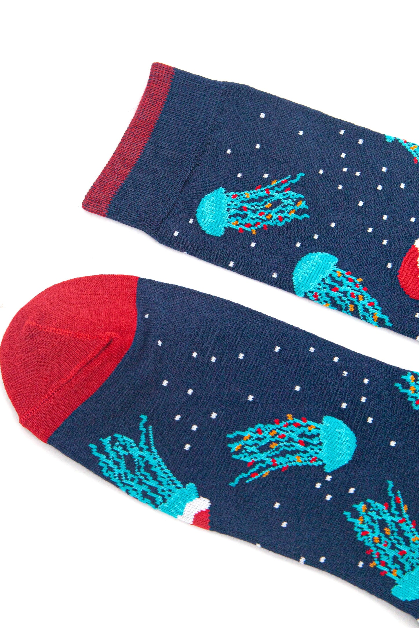 close up of the toe and cuff of the socks, both are red and contrast the navy blue body of the socks