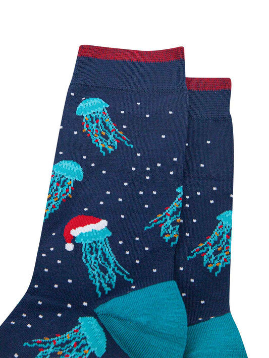 close up of the jellyfish pattern on the sock, they are electric blue with long tentacles, some have colourful party lights entwined in their tentacles, others are wearing red santa hats
