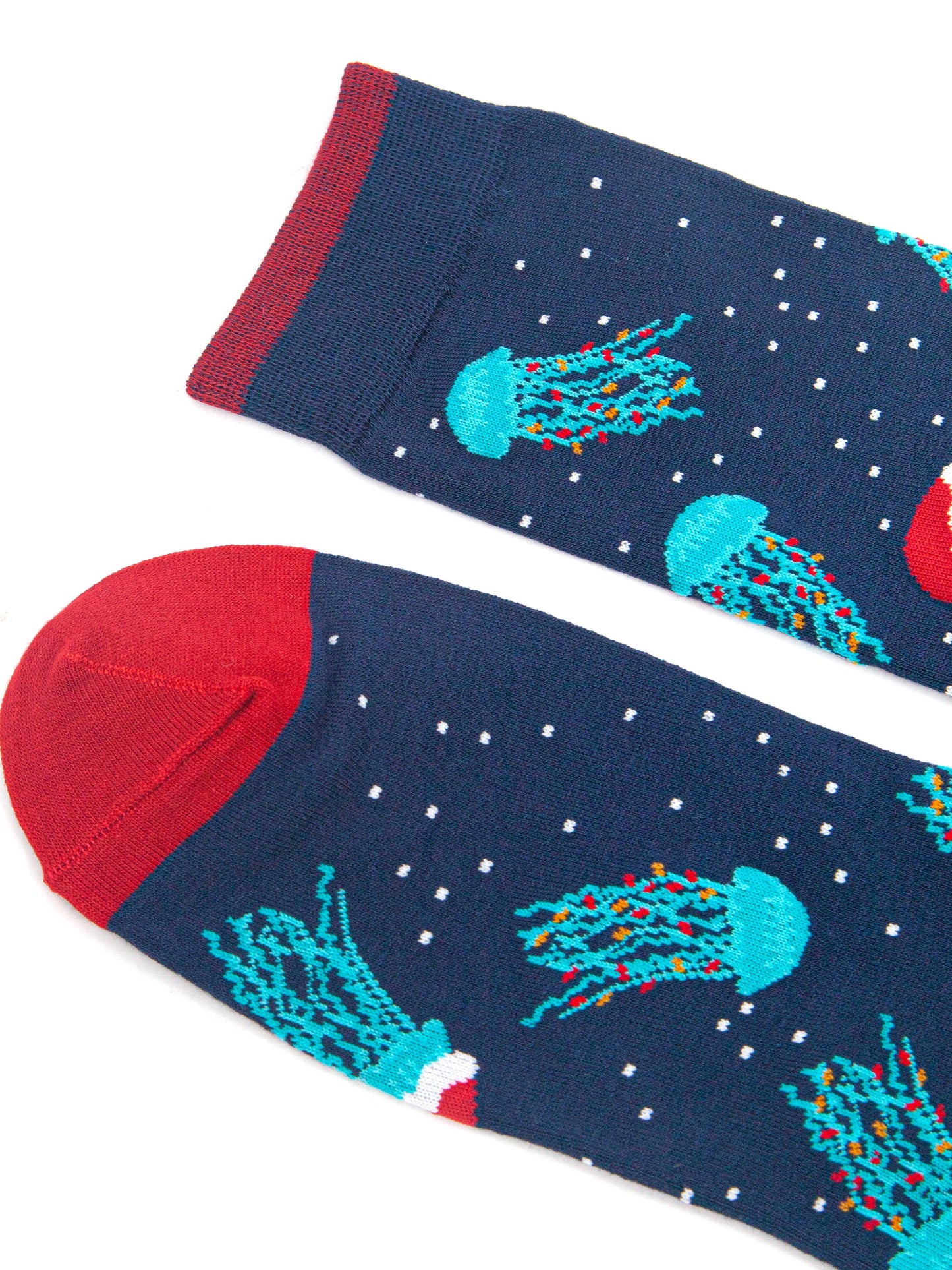 close up of the toe and cuff of the socks, both are red and contrast the navy blue body of the socks