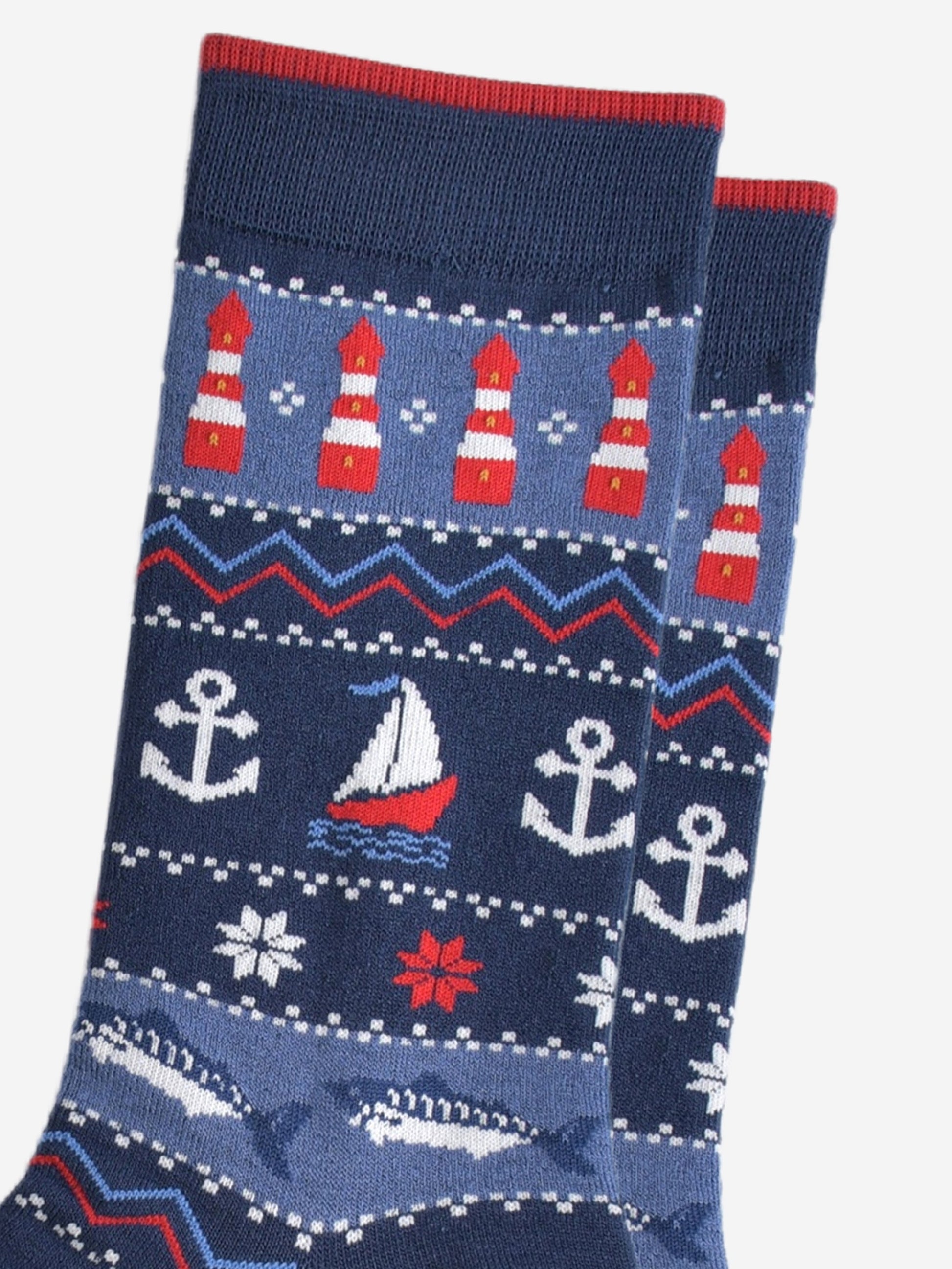 close up of the nautical designs on the socks, the lighthouses, boats, anchors and fish are shown