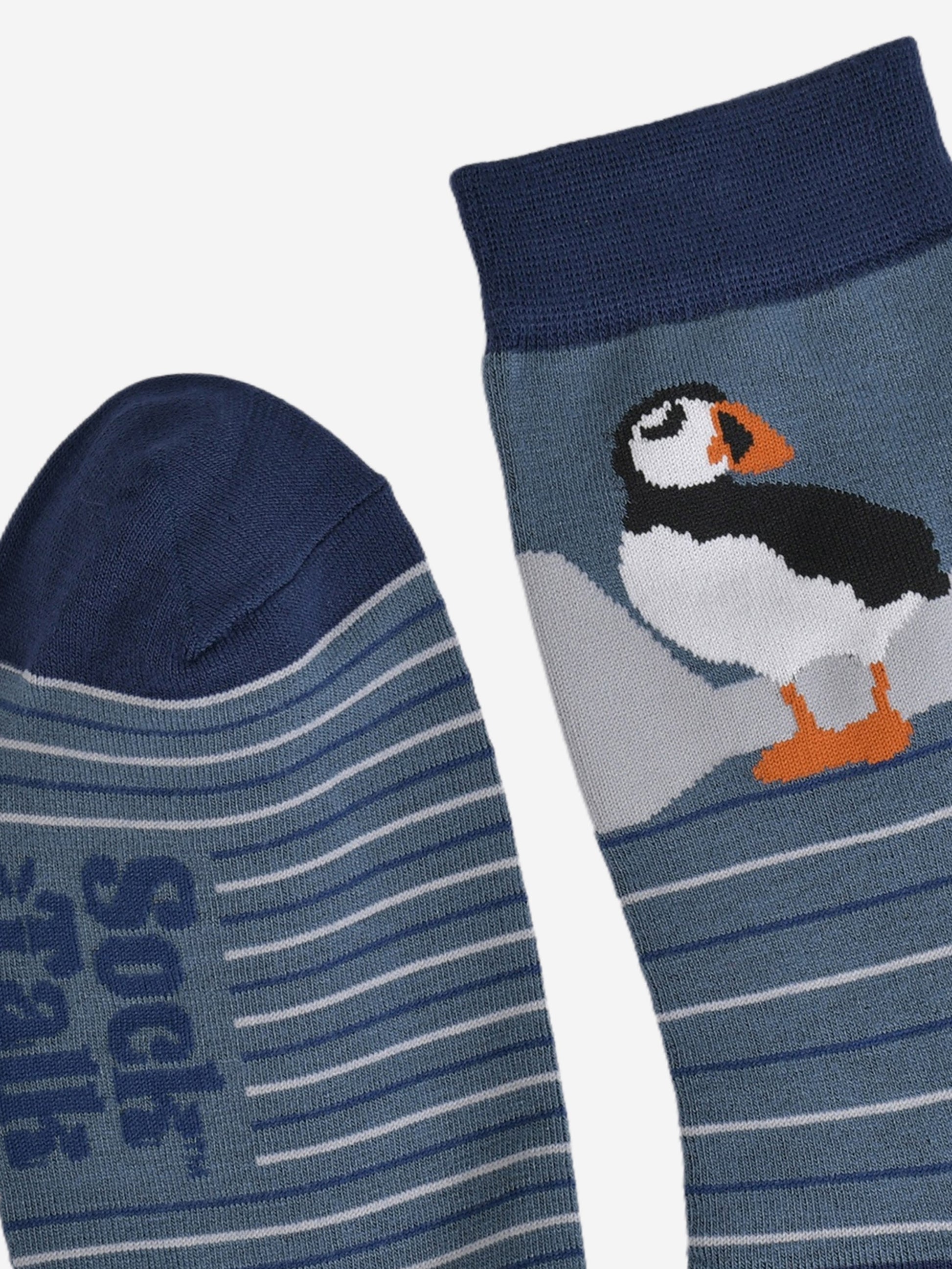 close up of the toe and cuff, both are navy blue in contrast to the teal blue background of the socks