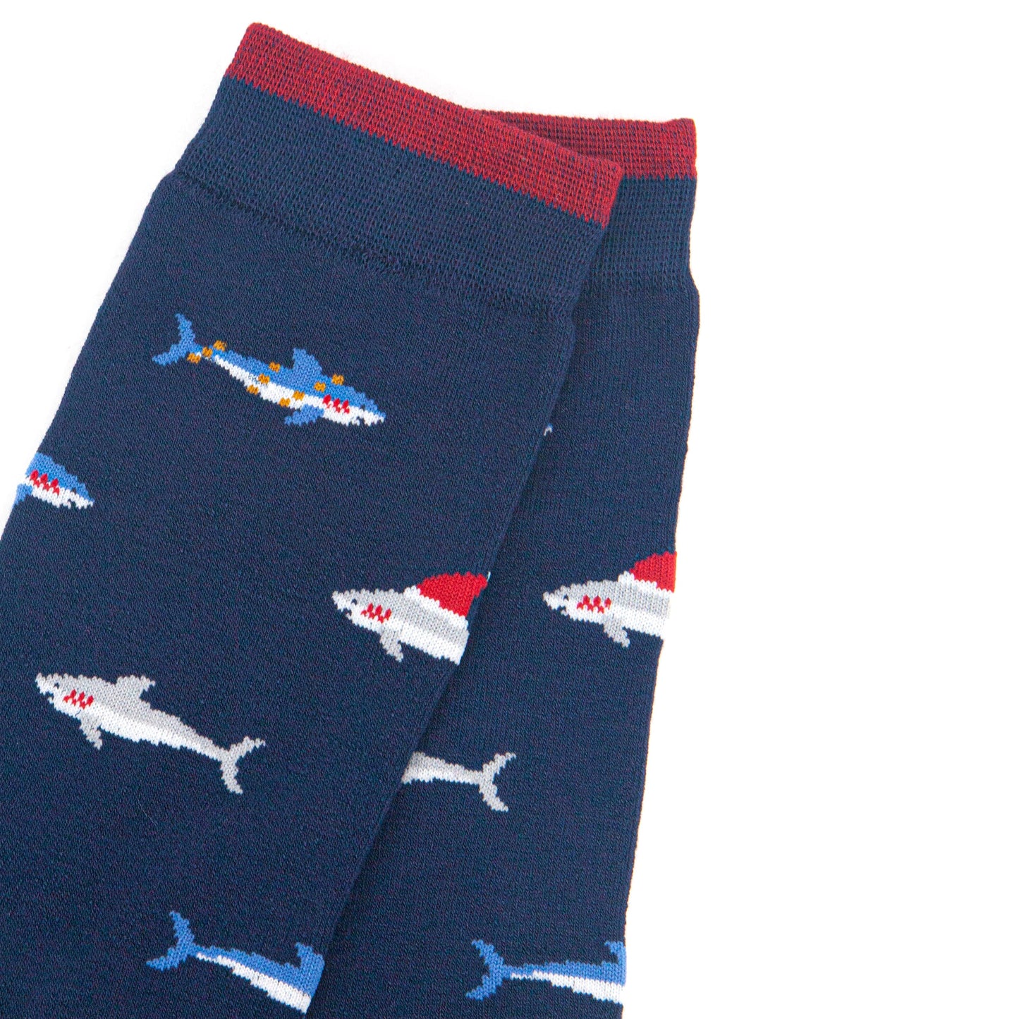 close up of the shark pattern, there are grey sharks wearing santa hats and blue sharks entangled in party lights