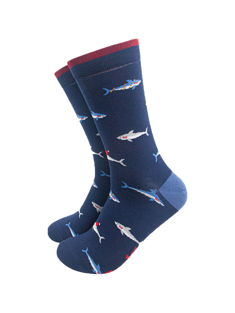 navy blue bamboo socks with a pattern of swimming sharks wearing santa hats