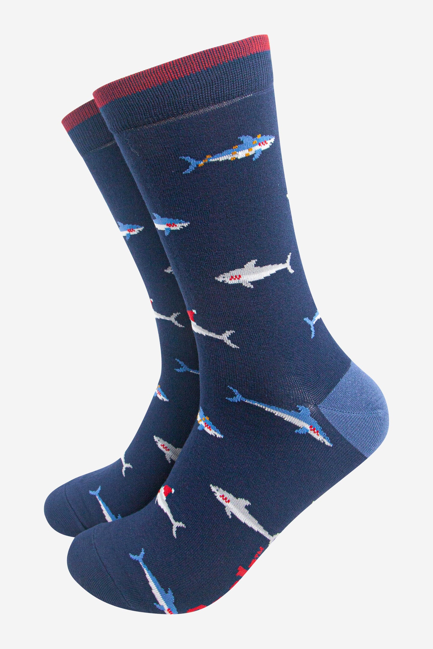 navy blue bamboo socks with a pattern of swimming sharks wearing santa hats