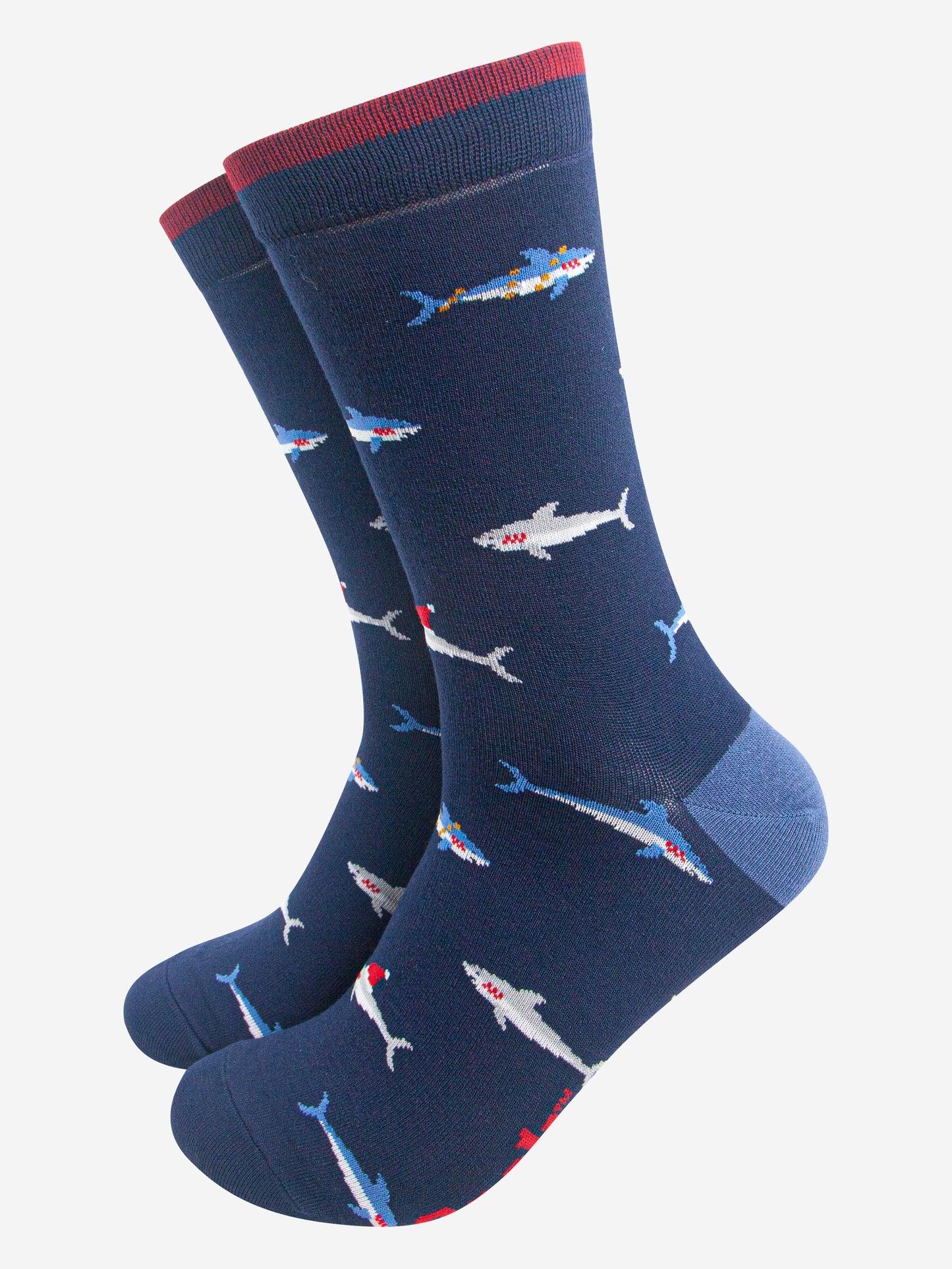 navy blue bamboo socks with a pattern of swimming sharks wearing santa hats