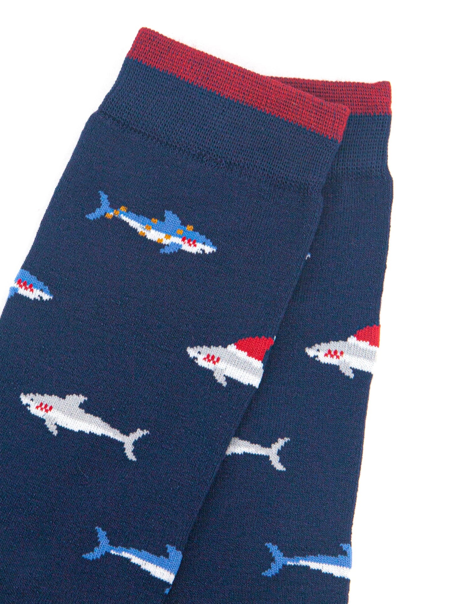 close up of the shark pattern, there are grey sharks wearing santa hats and blue sharks entangled in party lights